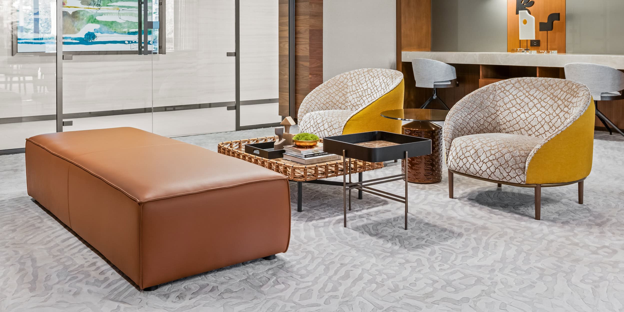 Stylish modern hotel lounge area with contemporary seating and decorative tables for relaxing or socializing.