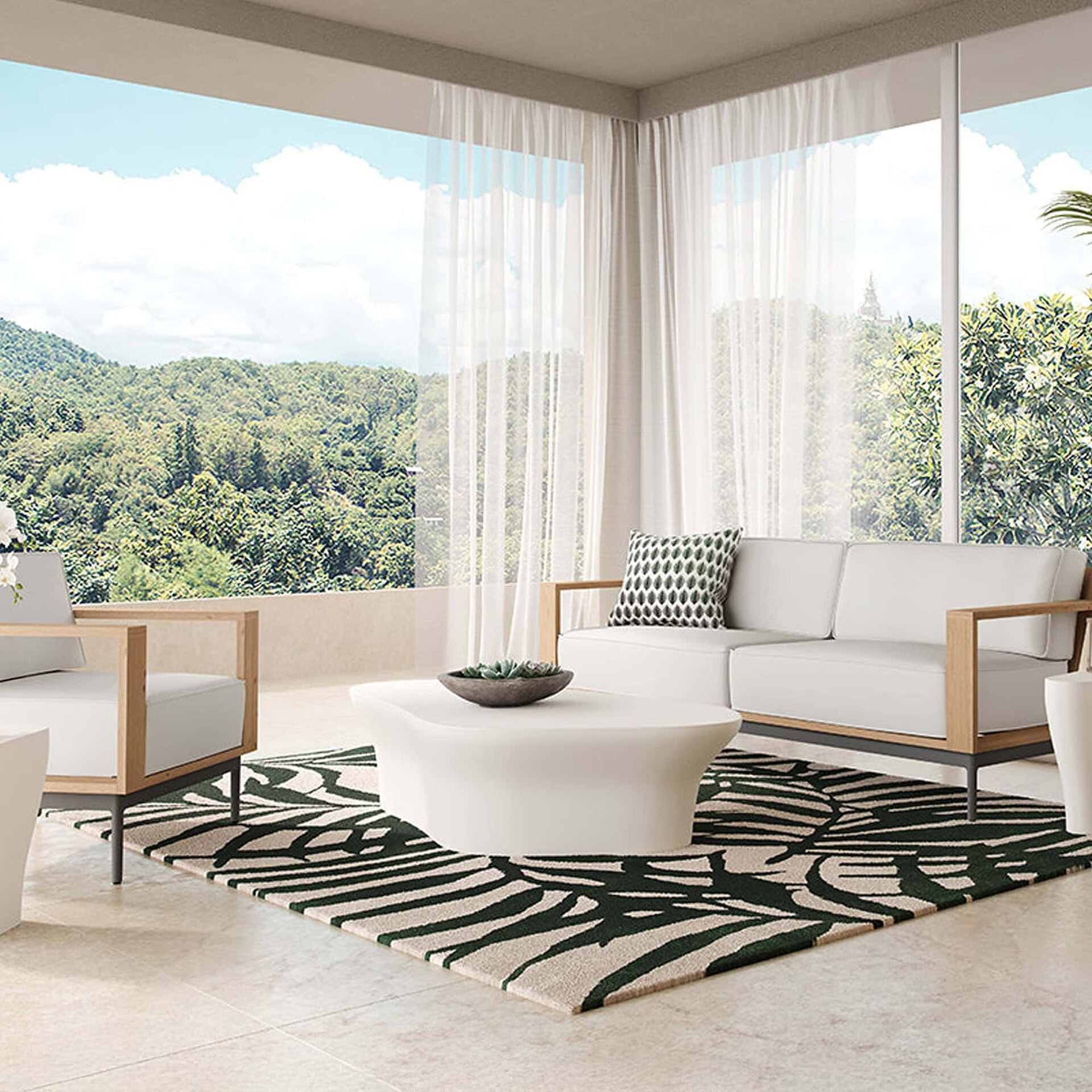 White sculptural concrete coffee table styled in a bright living room with floor-to-ceiling windows and modern lounge seating.