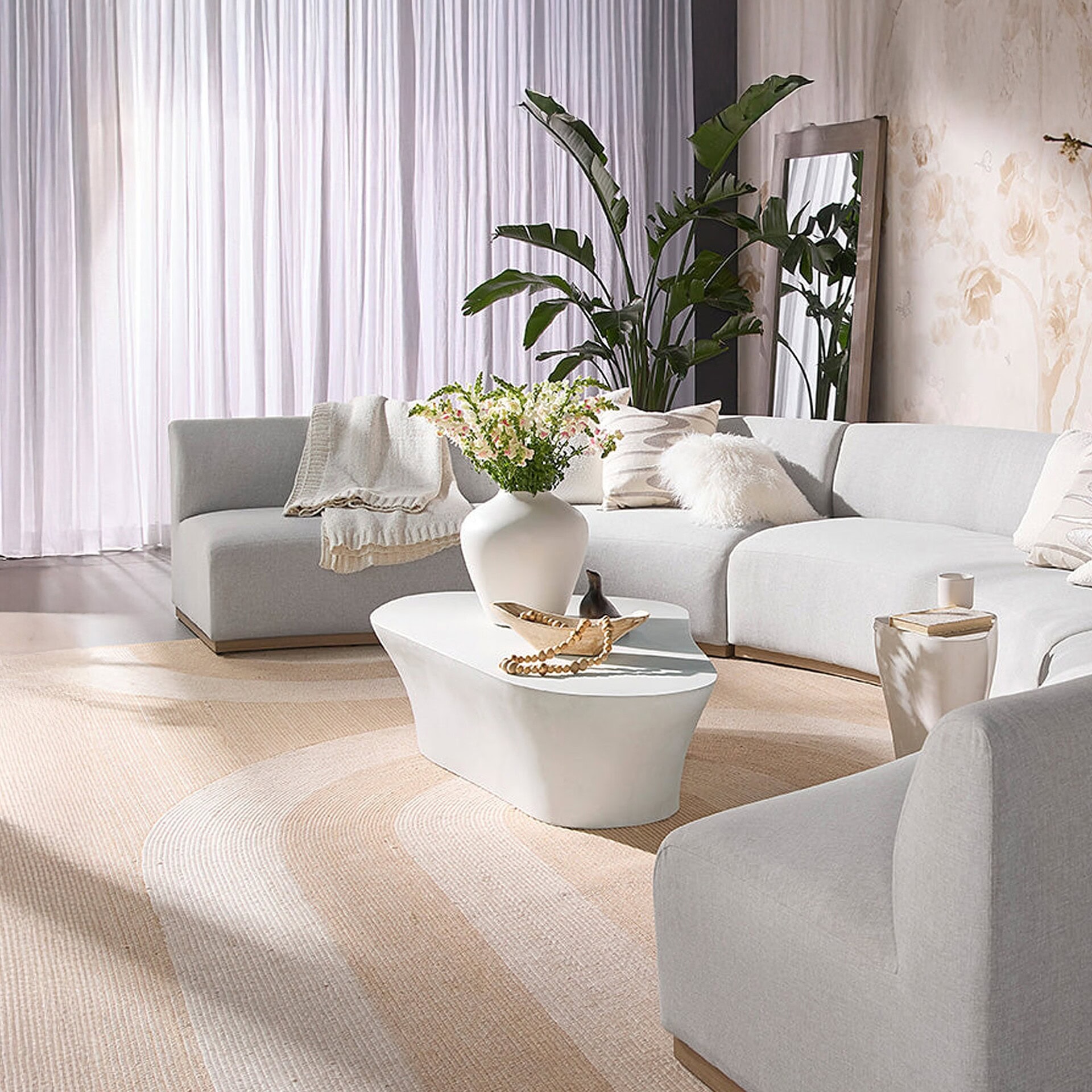 Luxurious modern living room with white sofa, elegant coffee table, and stylish decor.