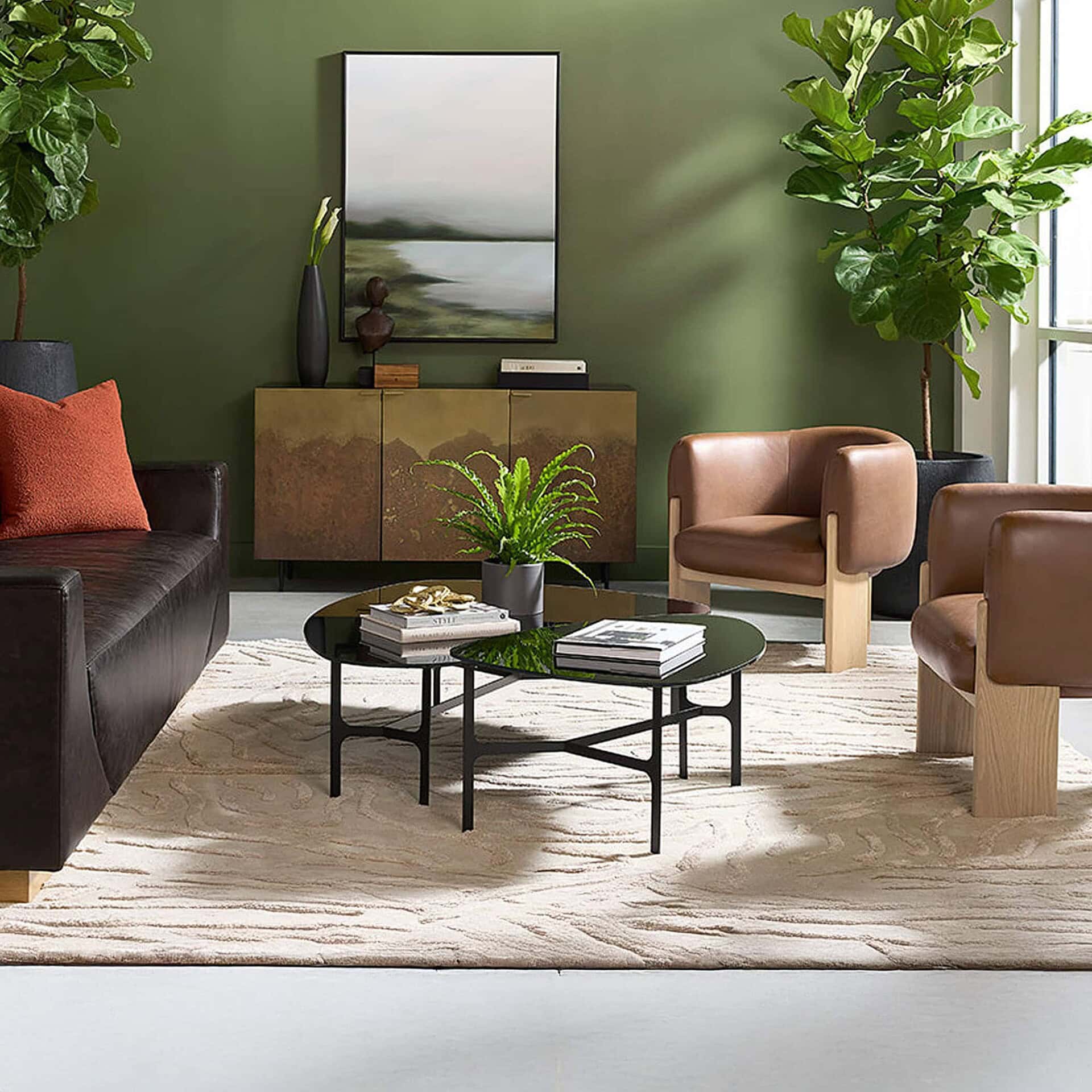 Modern living room with leather and fabric seating, greenery, and sleek coffee table.