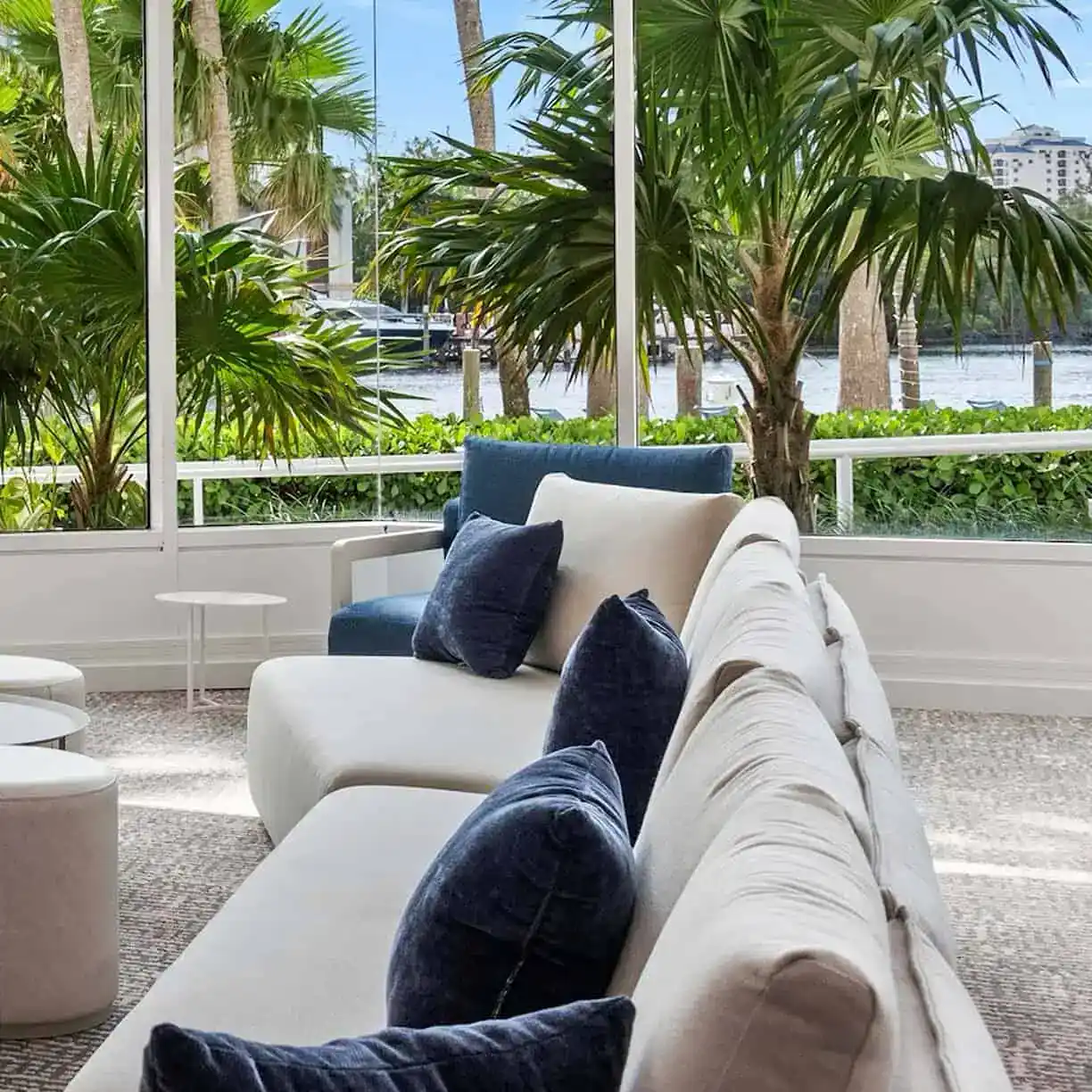 A Couch With Pillows In A Room With Palm Trees