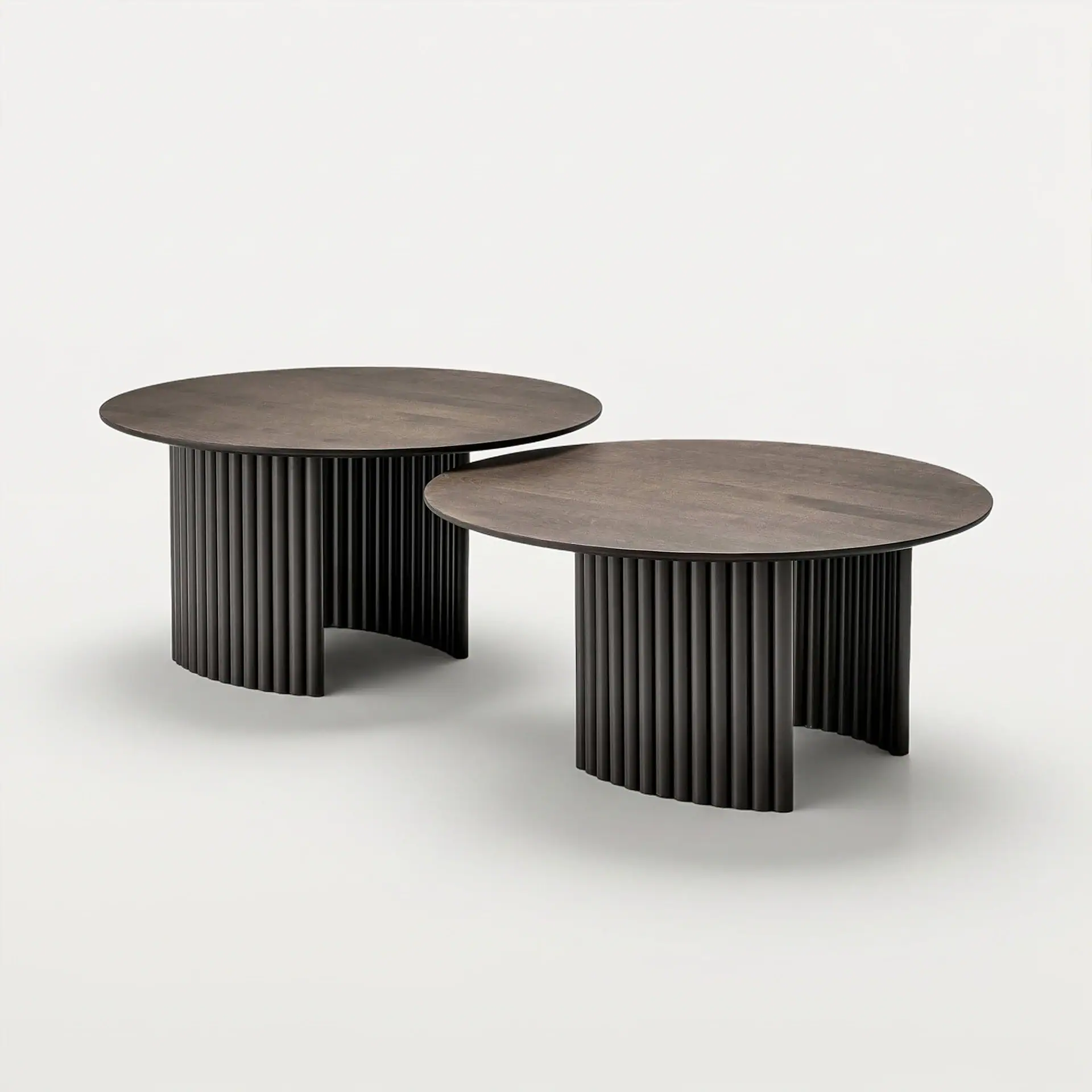 Modern Cove round coffee tables with ribbed black bases and wooden tops.