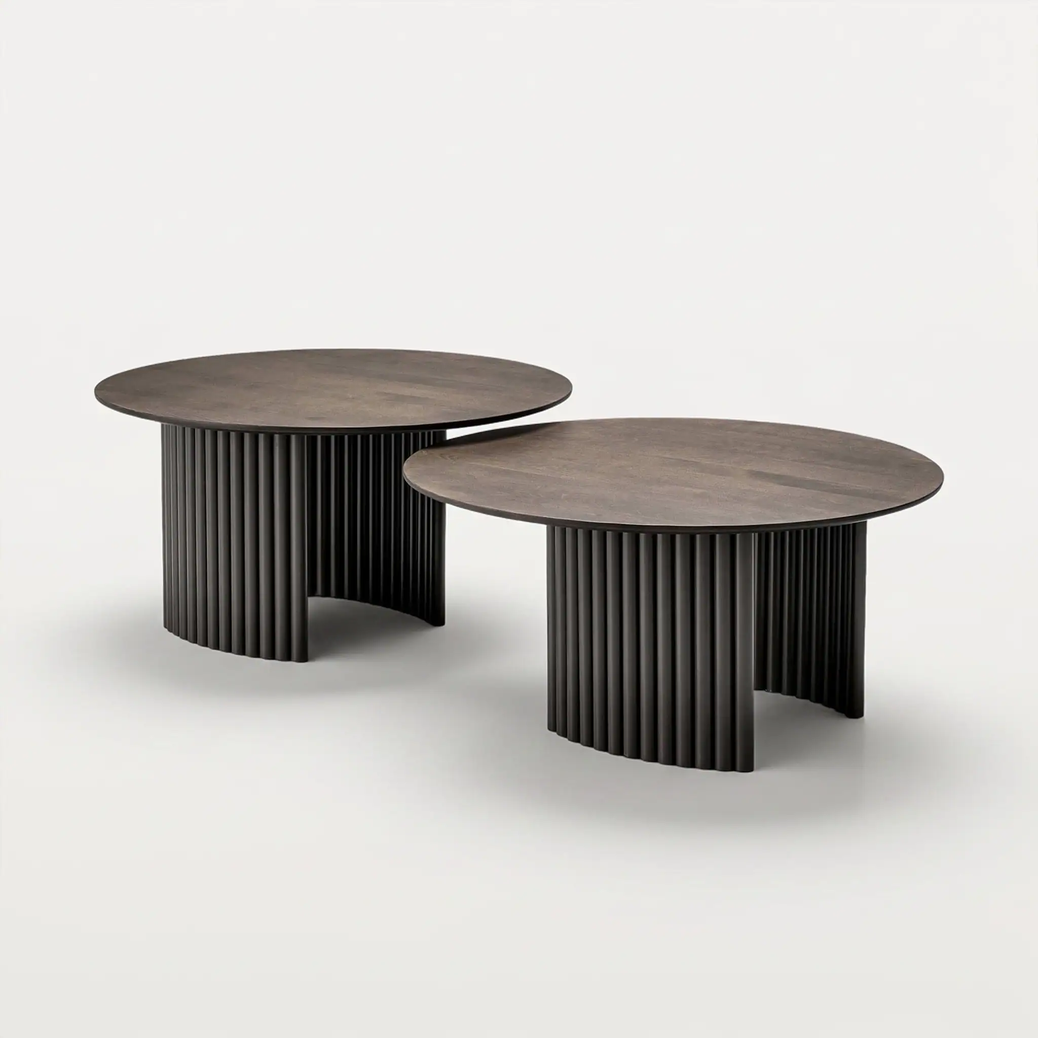Modern Cove round coffee tables with ribbed black bases and wooden tops.