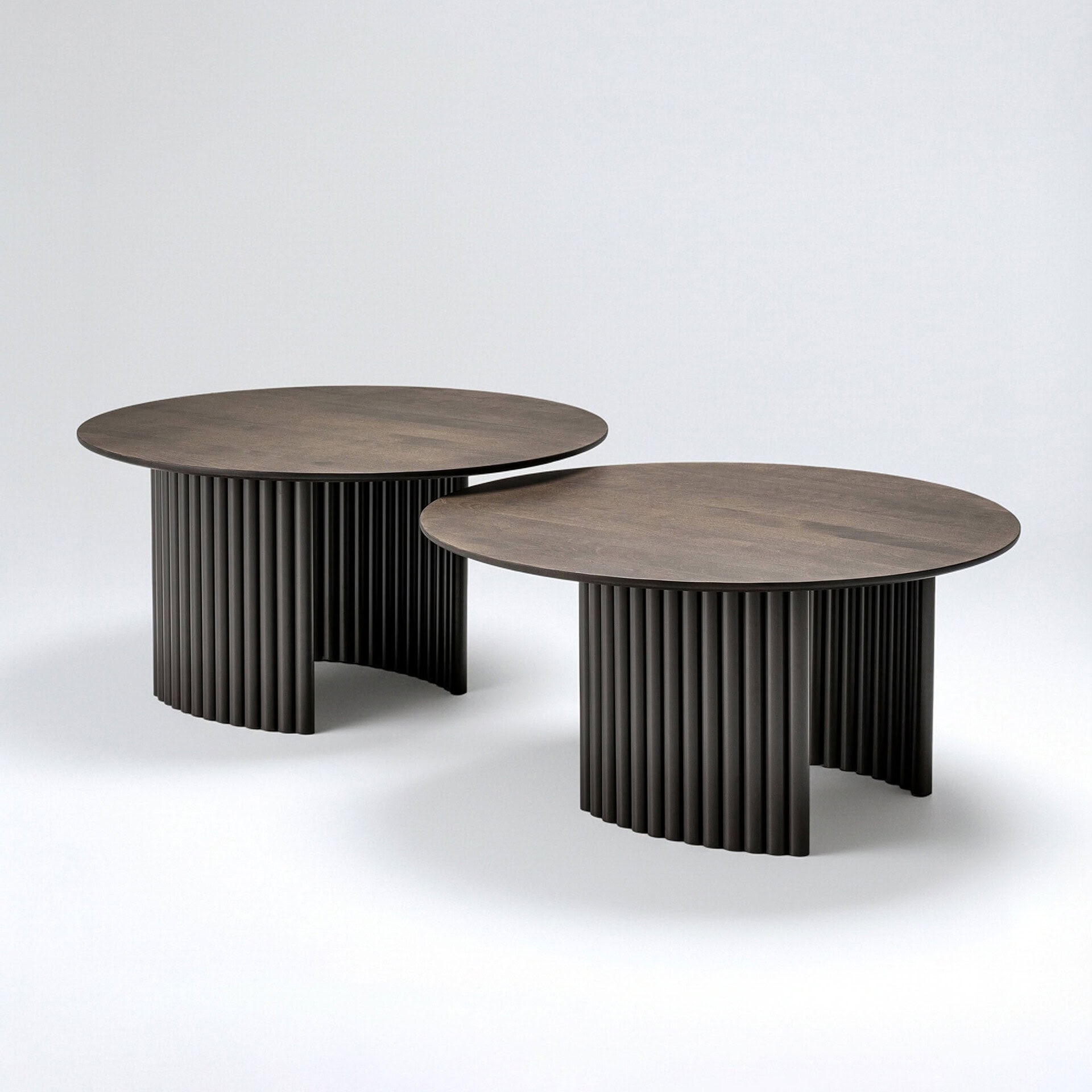 Elegant Cove Round Coffee Table with ribbed black base and wooden top.