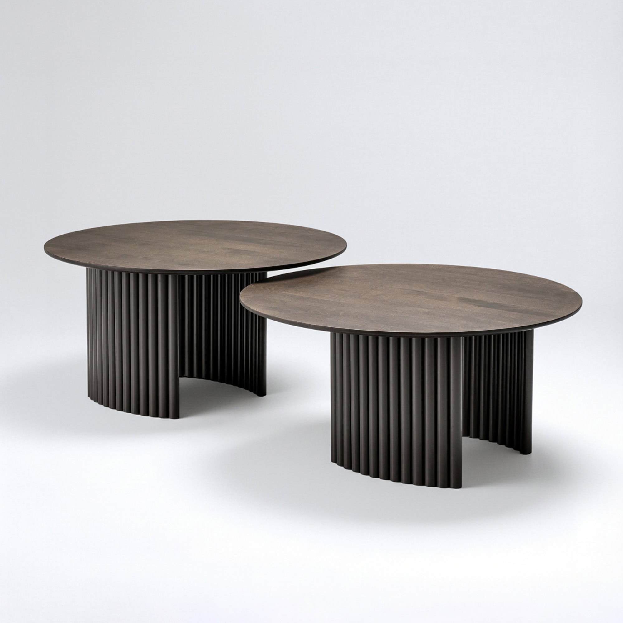 Elegant Cove Round Coffee Table with ribbed black base and wooden top.
