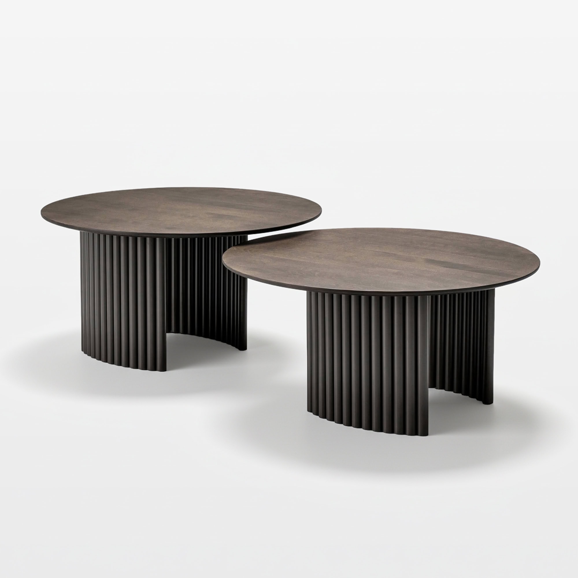 Elegant Cove Round Coffee Table with ribbed black base and wooden top.