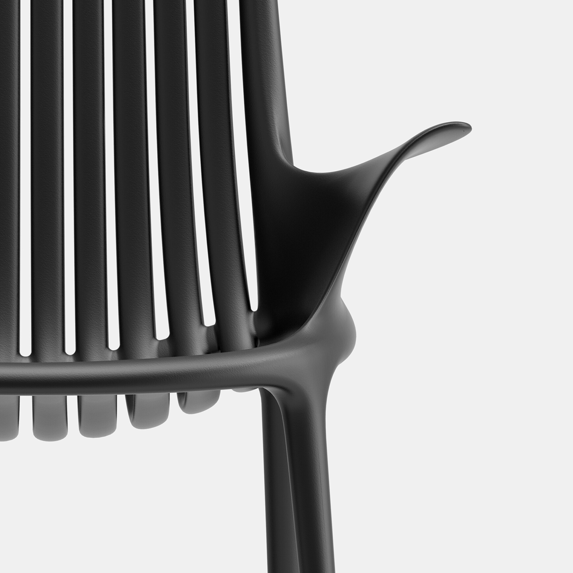 Close-up of a black modern chair with a vertical slatted backrest and a smoothly curved armrest, set against a light gray background.