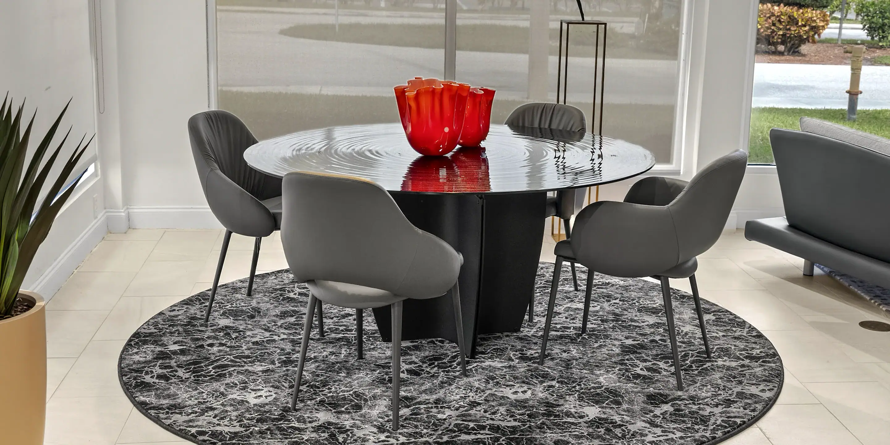 Contemporary dining room with modern black round table and stylish gray chairs, perfect for elegant gatherings.