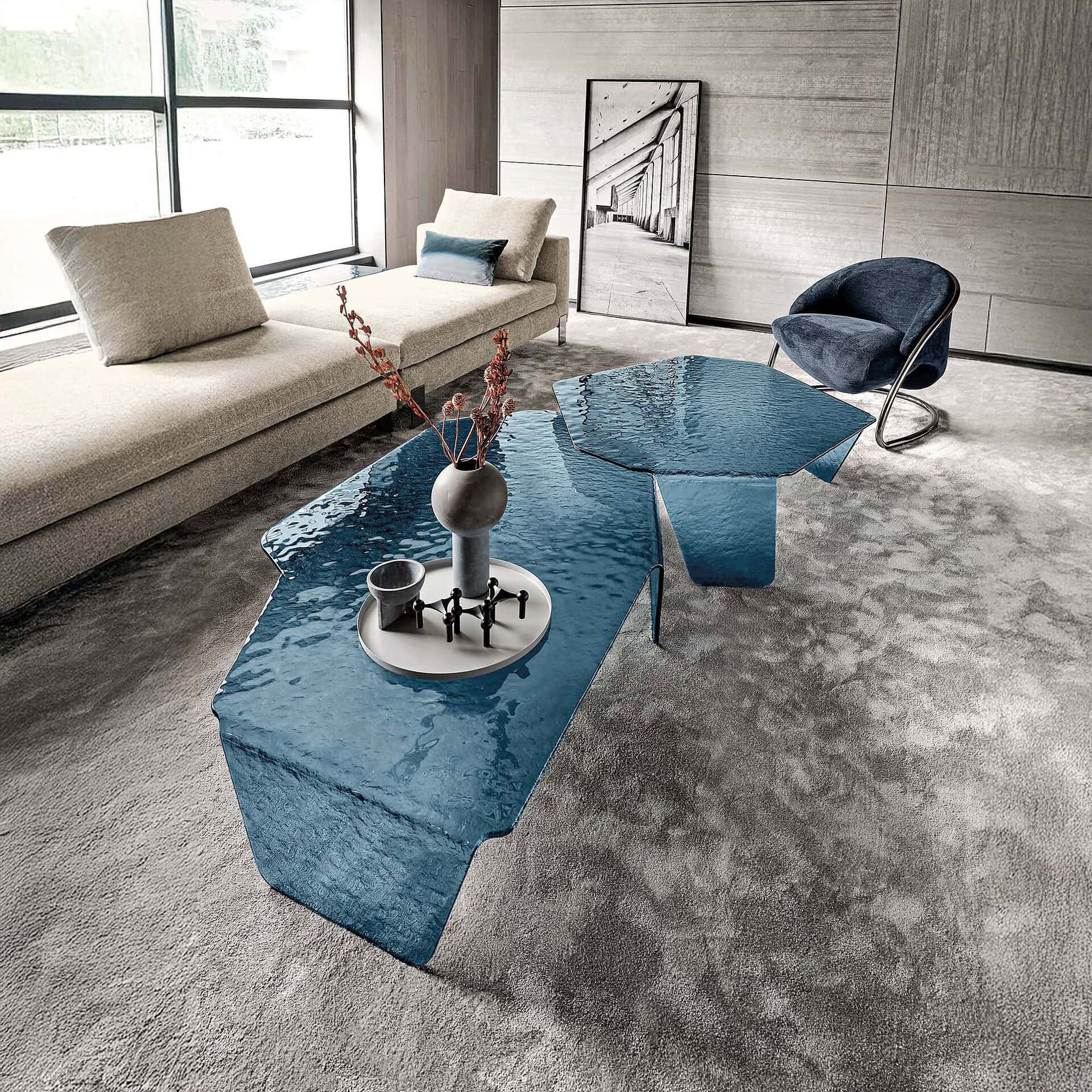 Stunning modern living room with glass coffee tables, plush sofa, and contemporary decor by Sklar Furnishings.