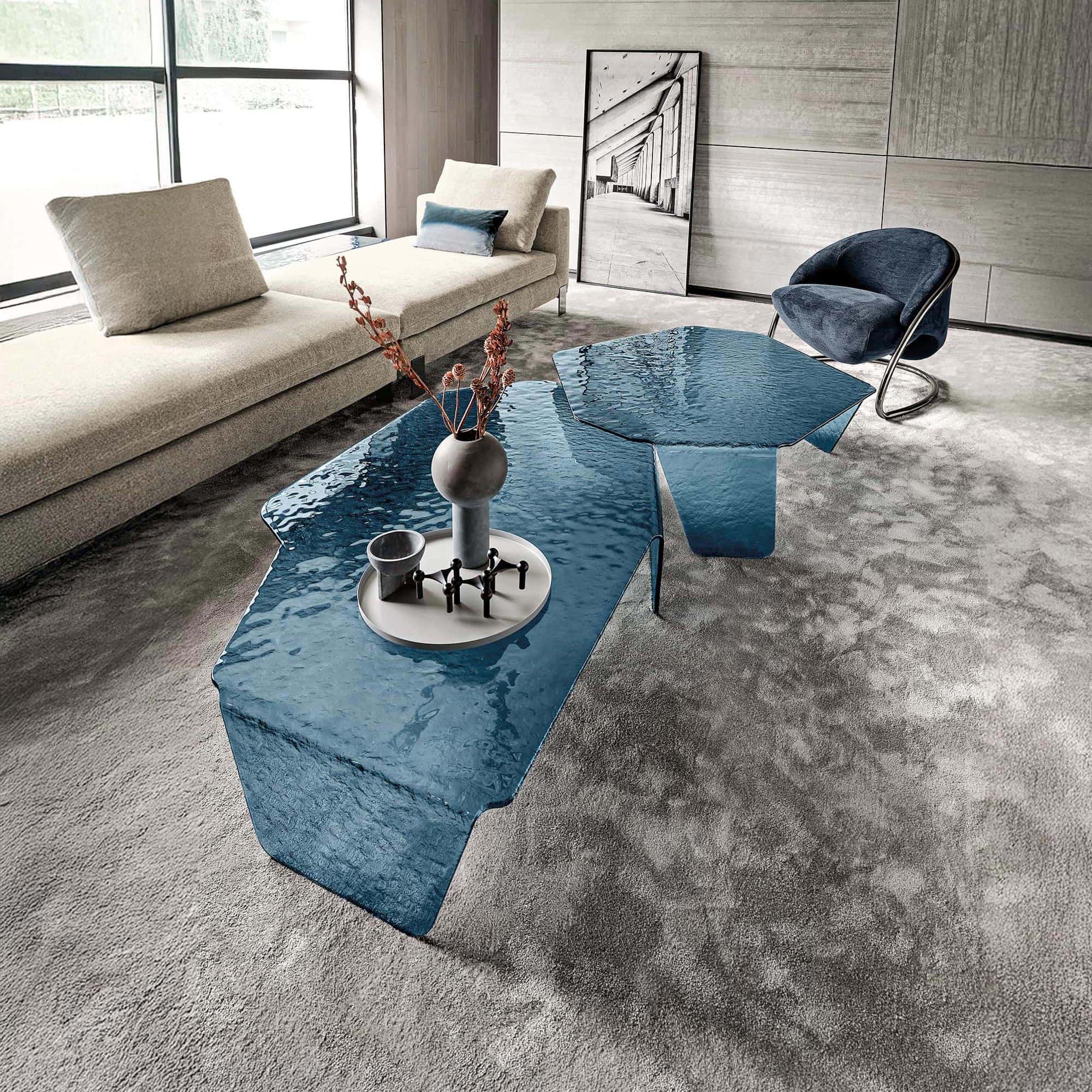 Stunning modern living room with glass coffee tables, plush sofa, and contemporary decor by Sklar Furnishings.