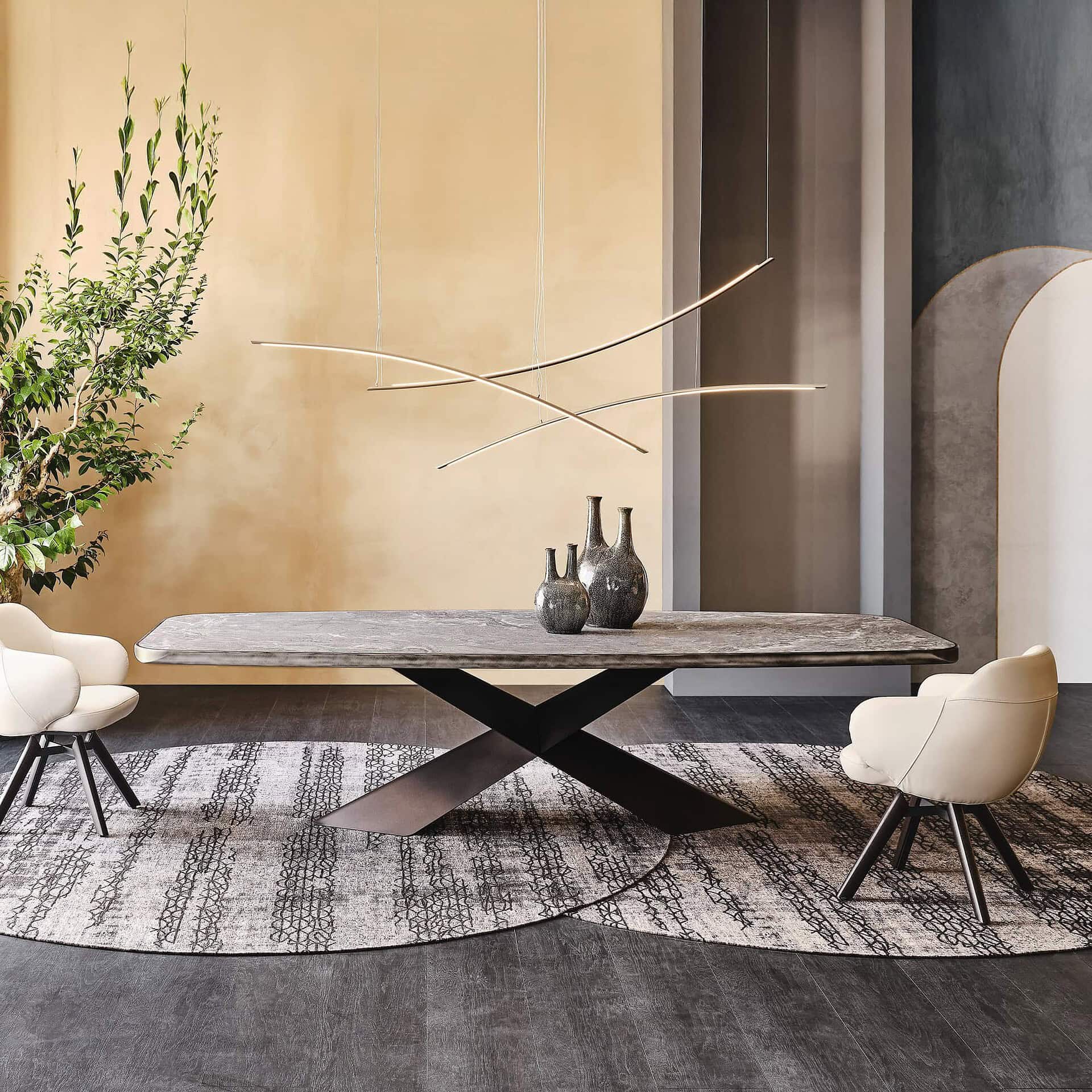 Sleek modern dining table with black base and textured gray surface in contemporary interior design.