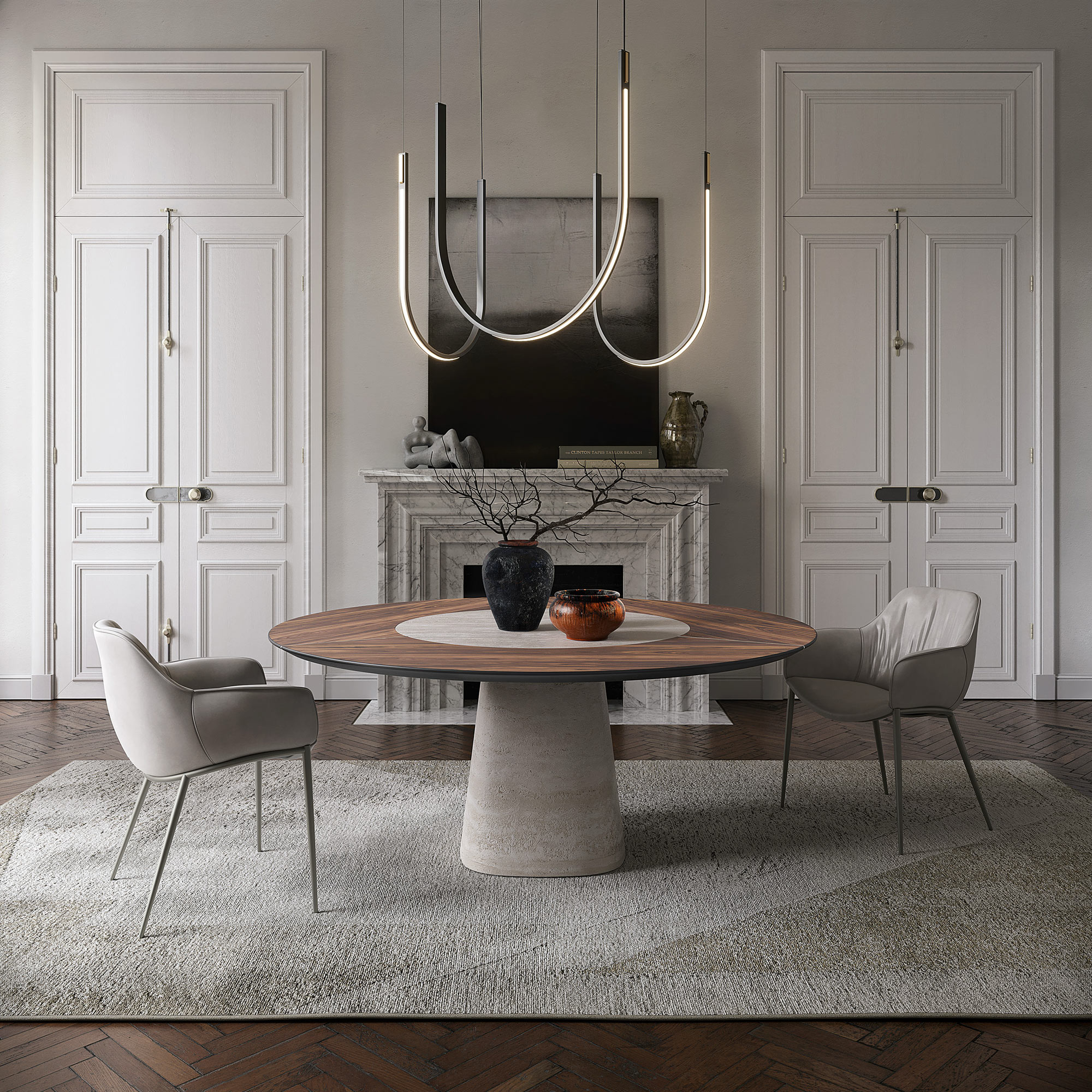 Rado Ker-Wood Round Dining Table styled in a modern dining room with upholstered chairs and a sculptural chandelier, featuring a Canaletto walnut top and ceramic base.
