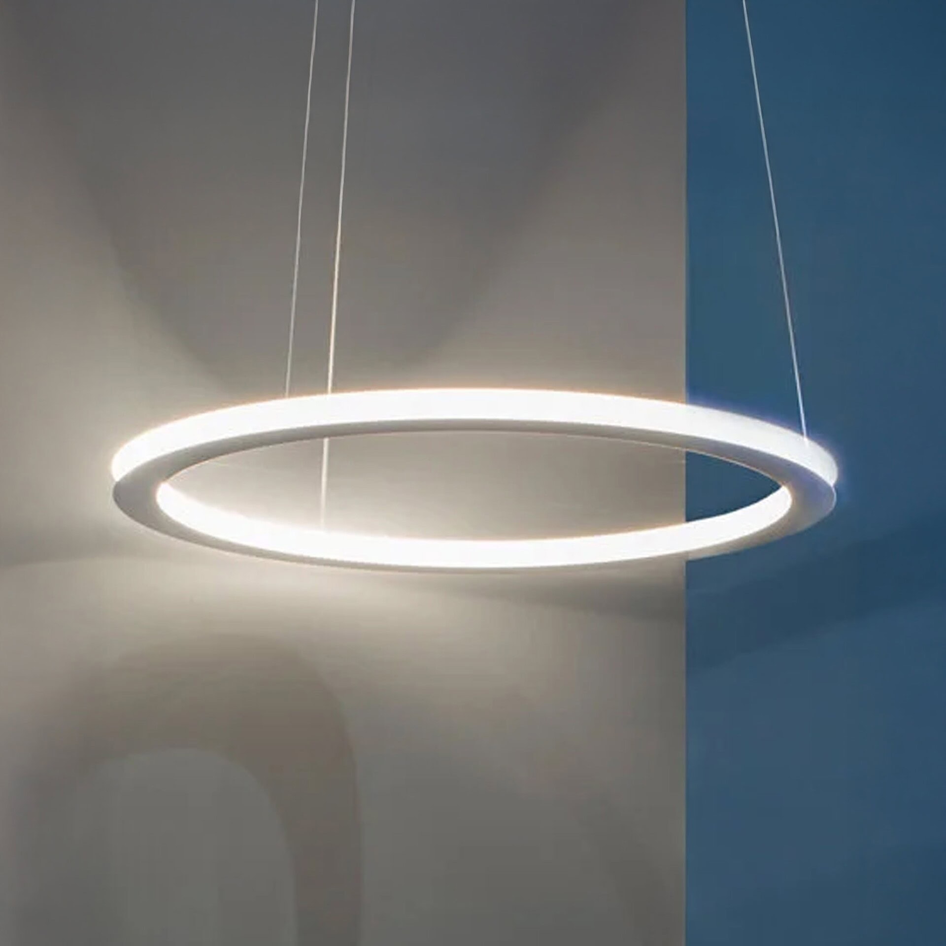 Ava Pendant Light suspended in a modern interior, glowing with soft illumination.