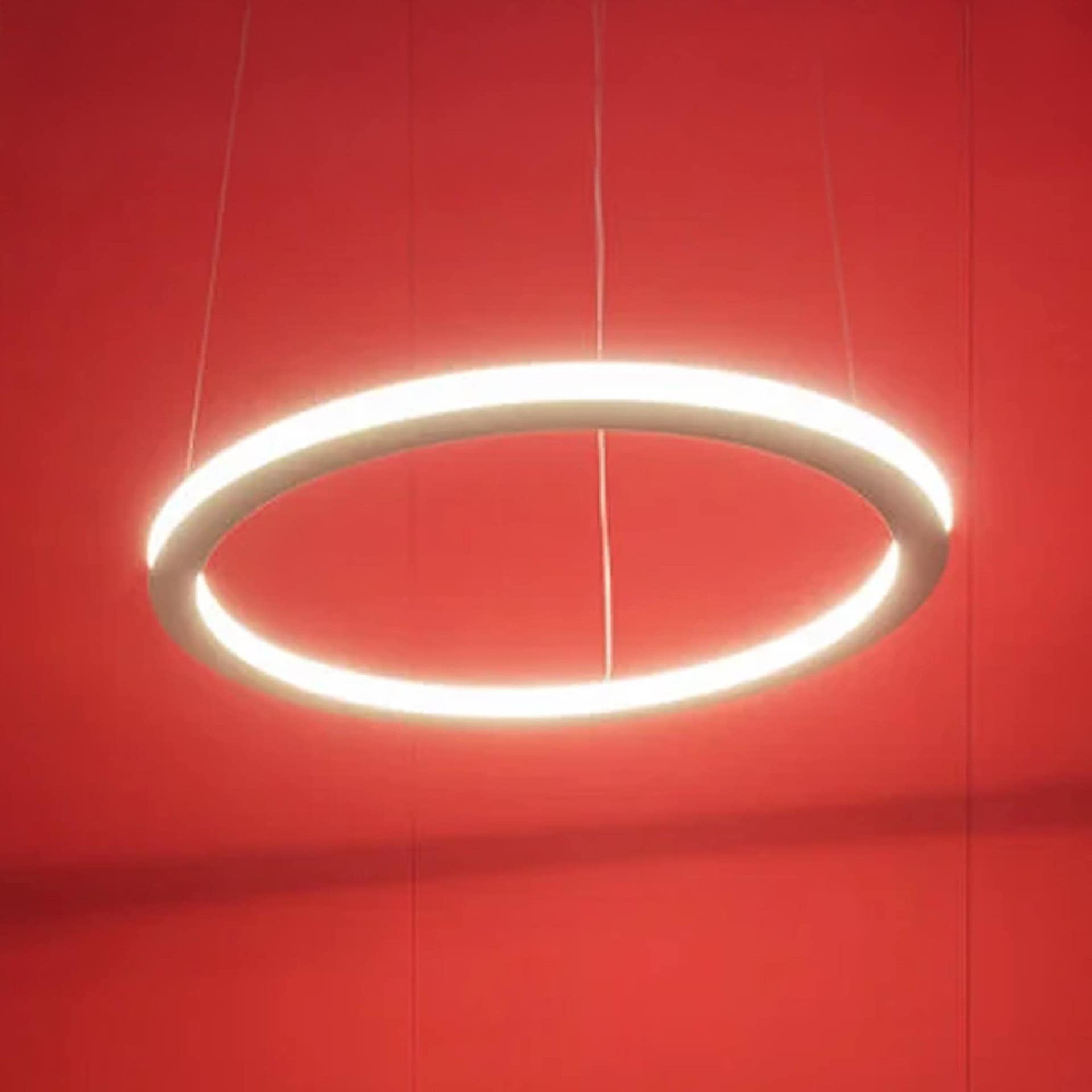Ava Pendant Light showcased against a bold red background, highlighting its sculptural form.
