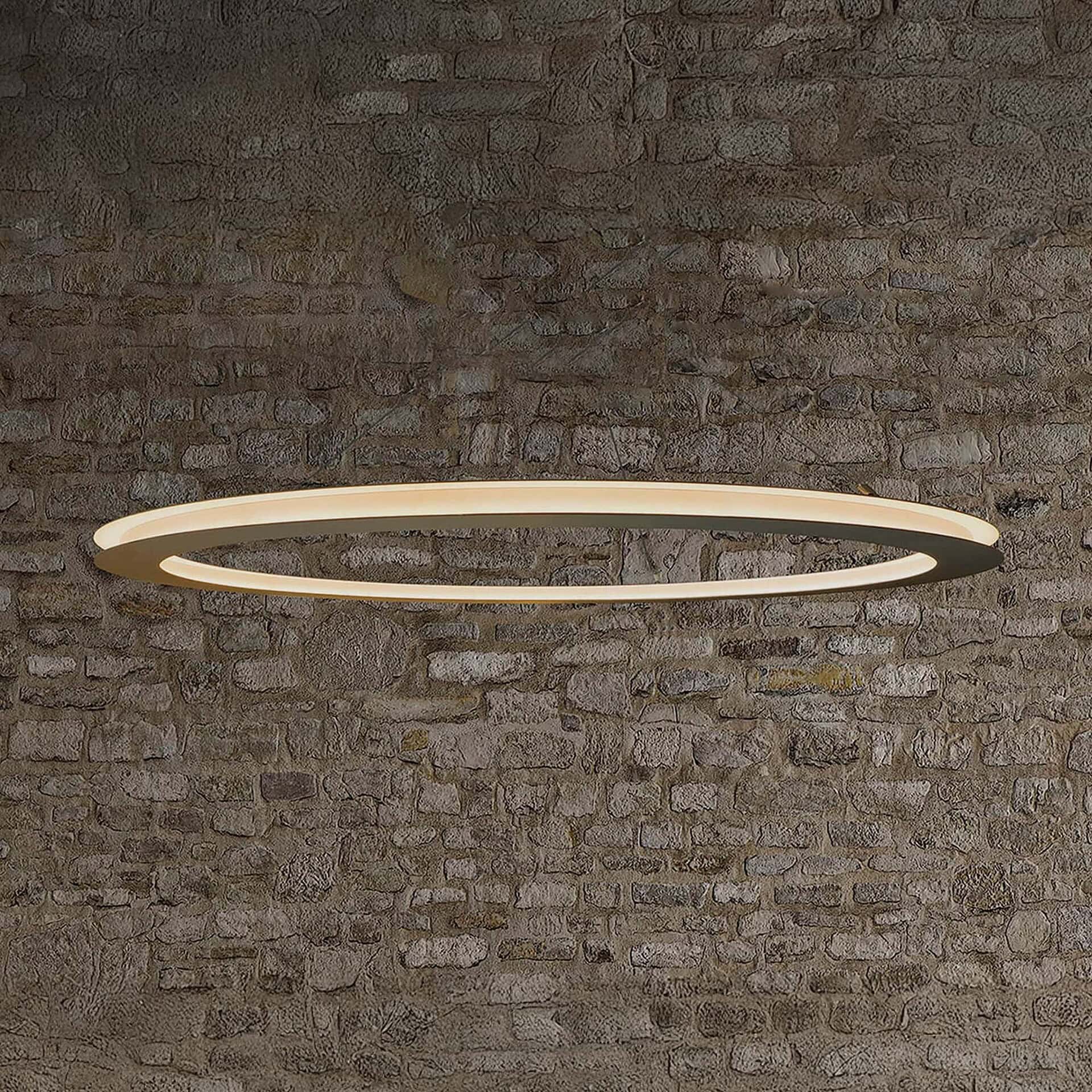 Ava Pendant Light displayed against a textured brick wall, creating contrast with its sleek design.