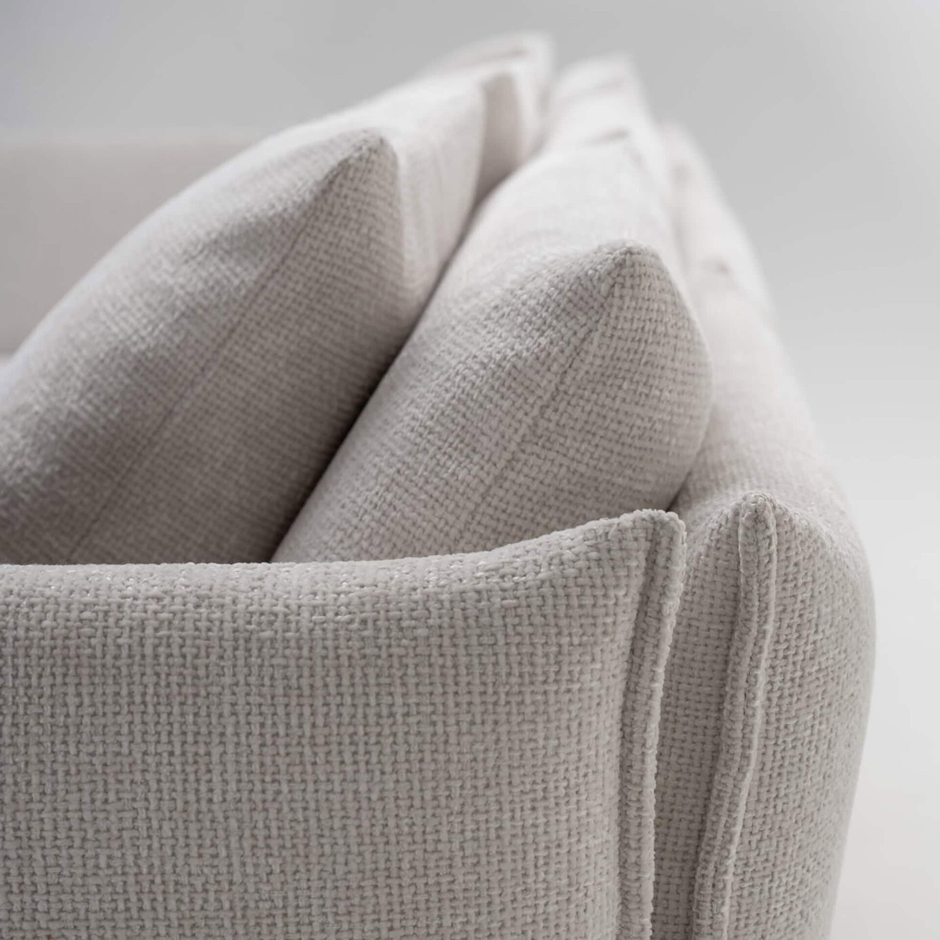 Luxurious beige textured upholstery sofa showcasing elegant modern furniture design.