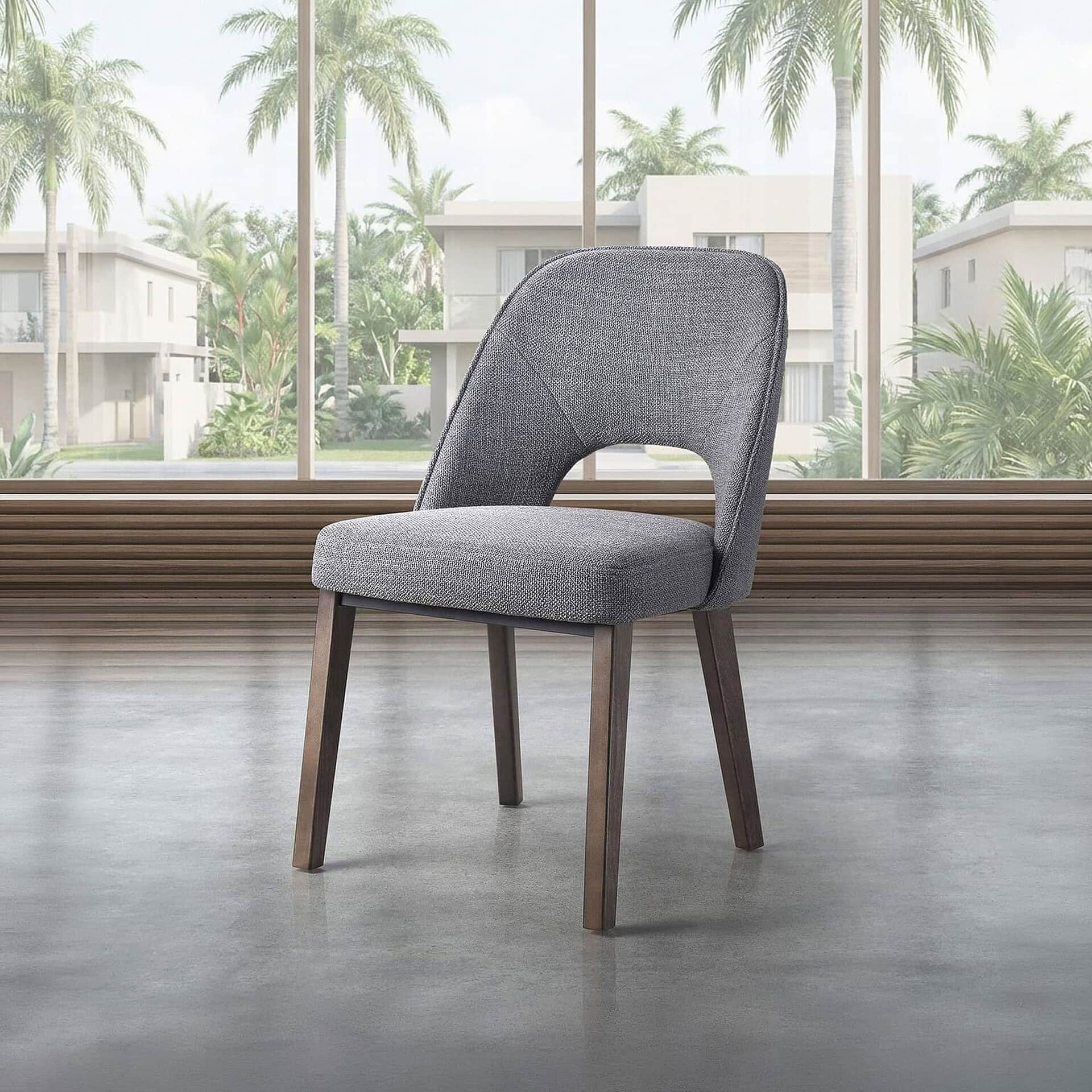 Upholstered dining chair with modern design and comfortable gray fabric. Perfect for contemporary di.