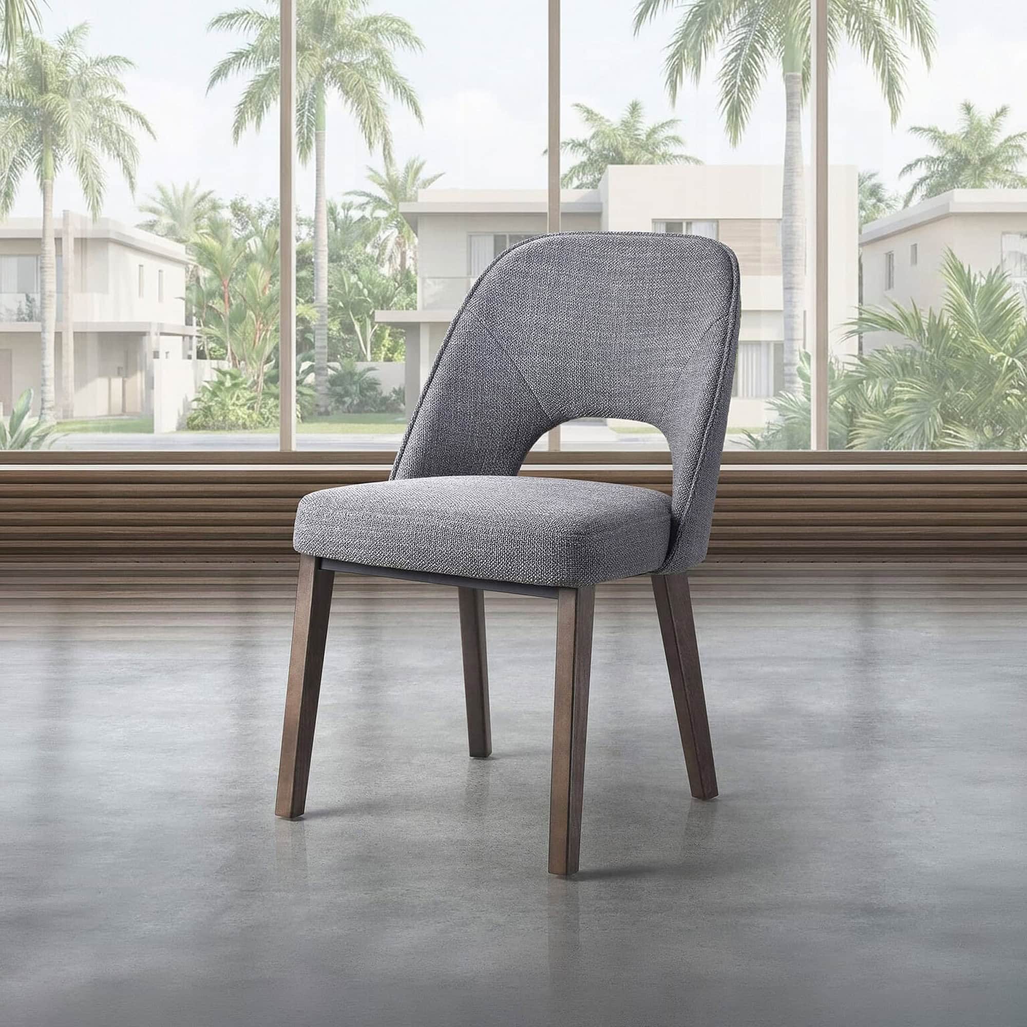 Upholstered dining chair with modern design and comfortable gray fabric. Perfect for contemporary di.
