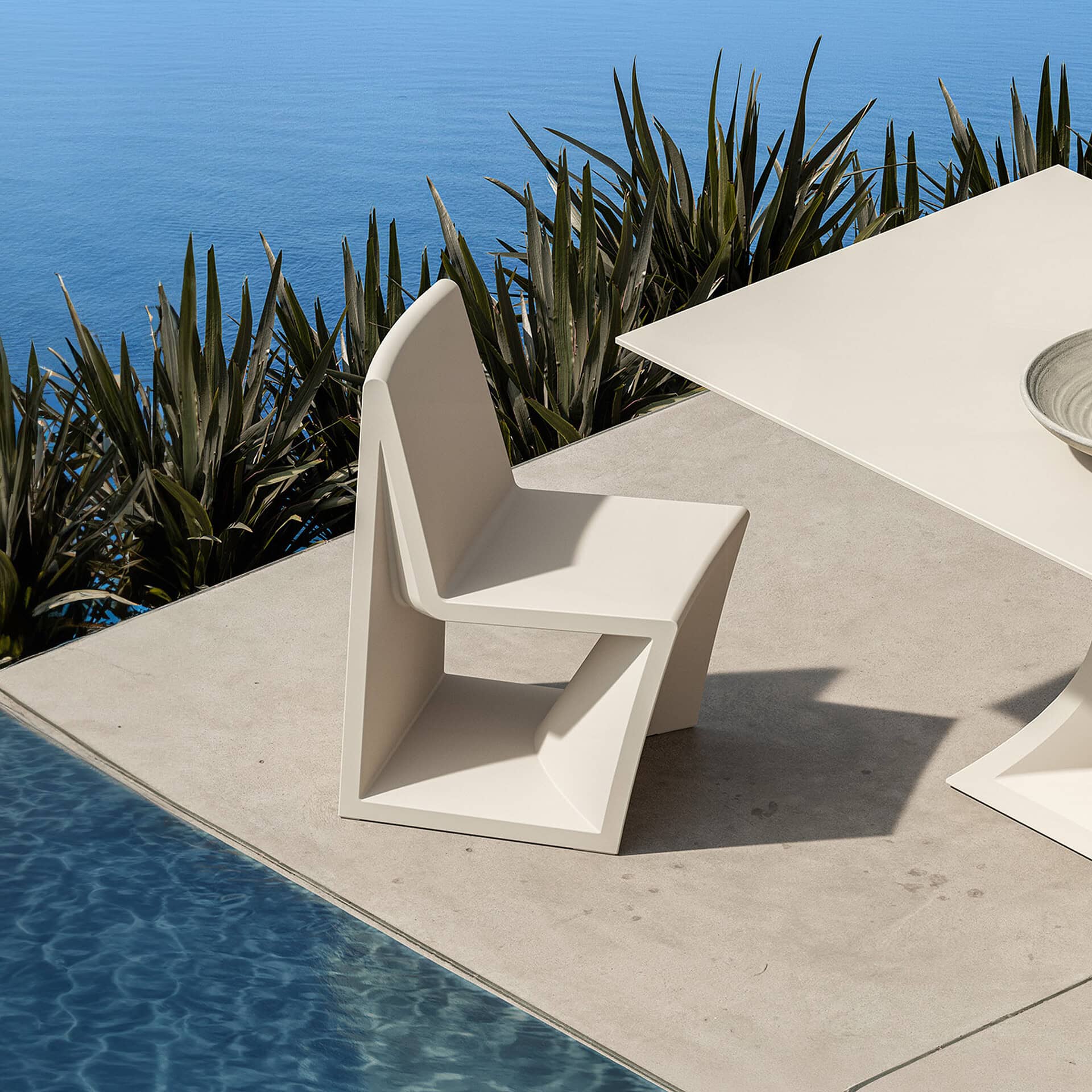 Elegant white outdoor chair with sleek design, perfect for patio or poolside settings.
