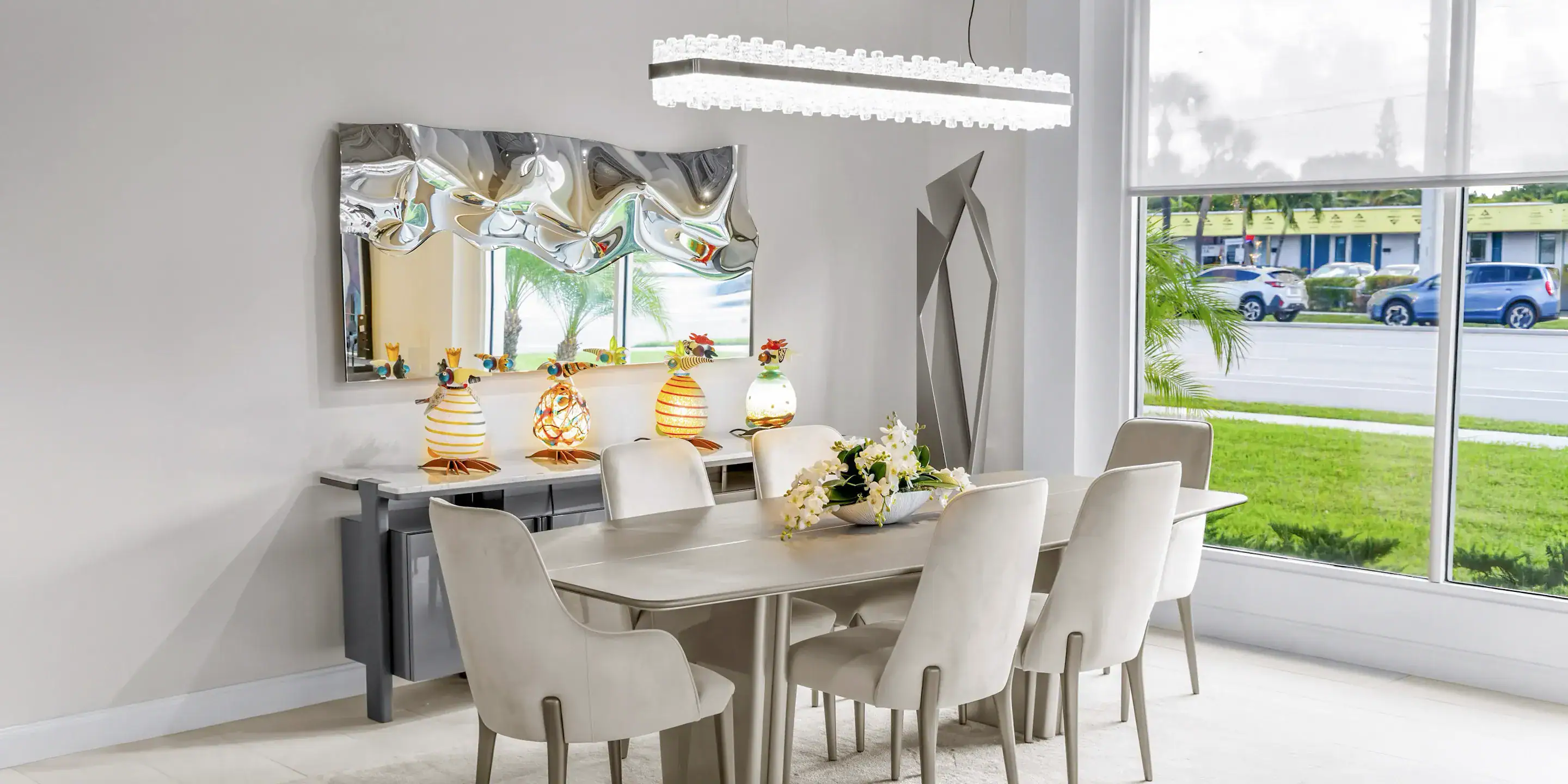 Contemporary dining room with sleek table and plush chairs, showcasing modern furniture design.