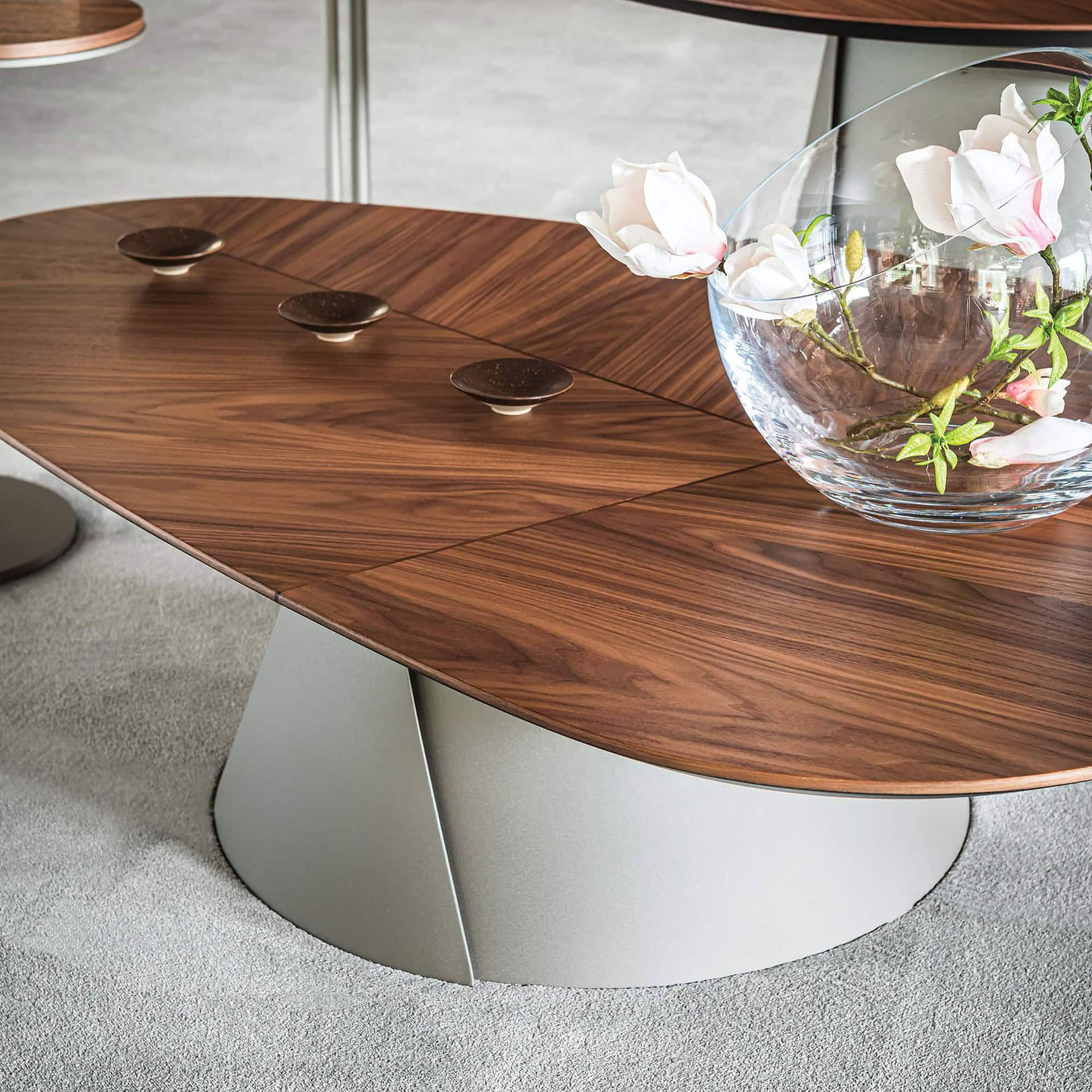 Luxury wooden coffee table with modern design and curved white base for contemporary living room.