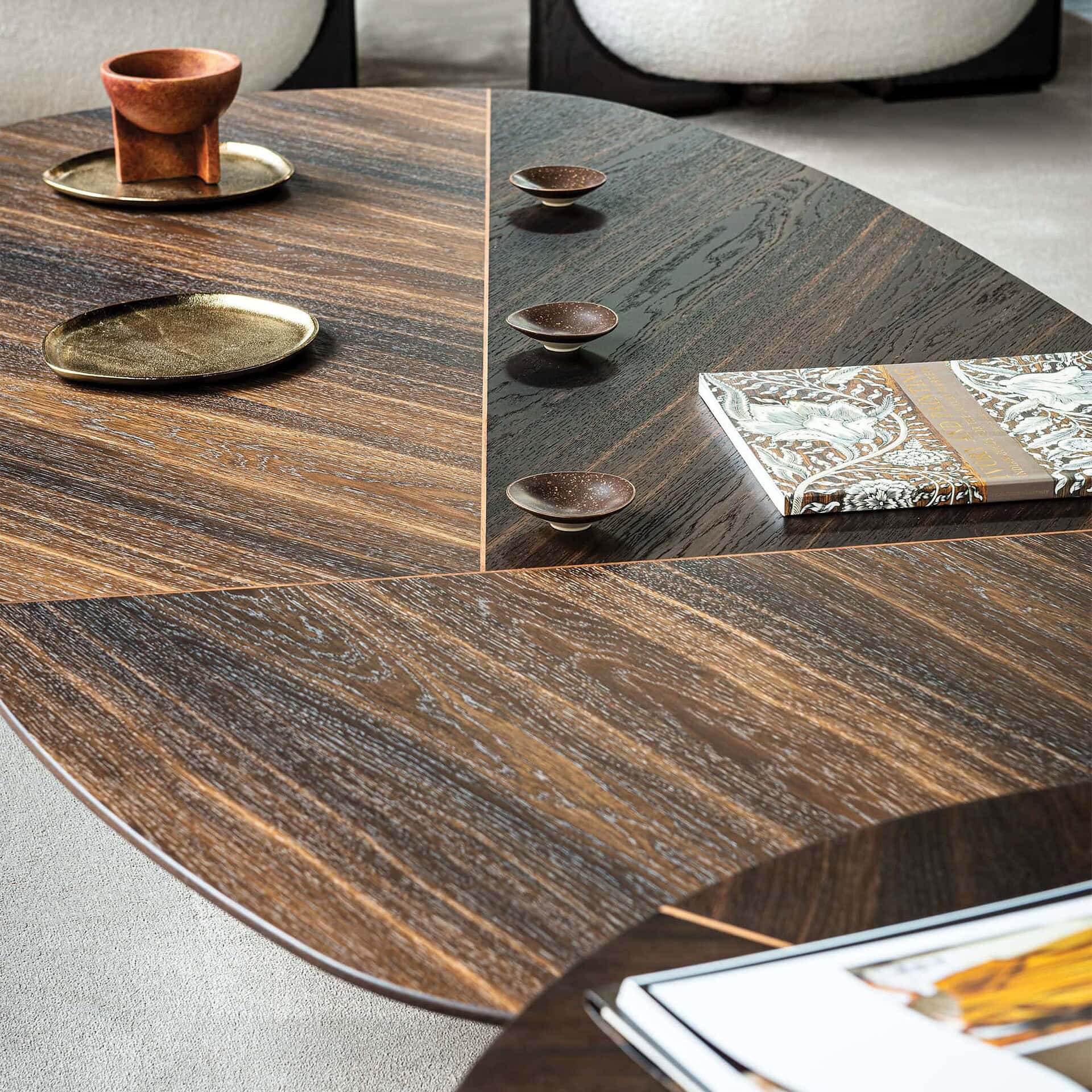 Handcrafted wooden dining table with elegant tableware and decor, showcasing luxury furniture from Sklar Furnishings.