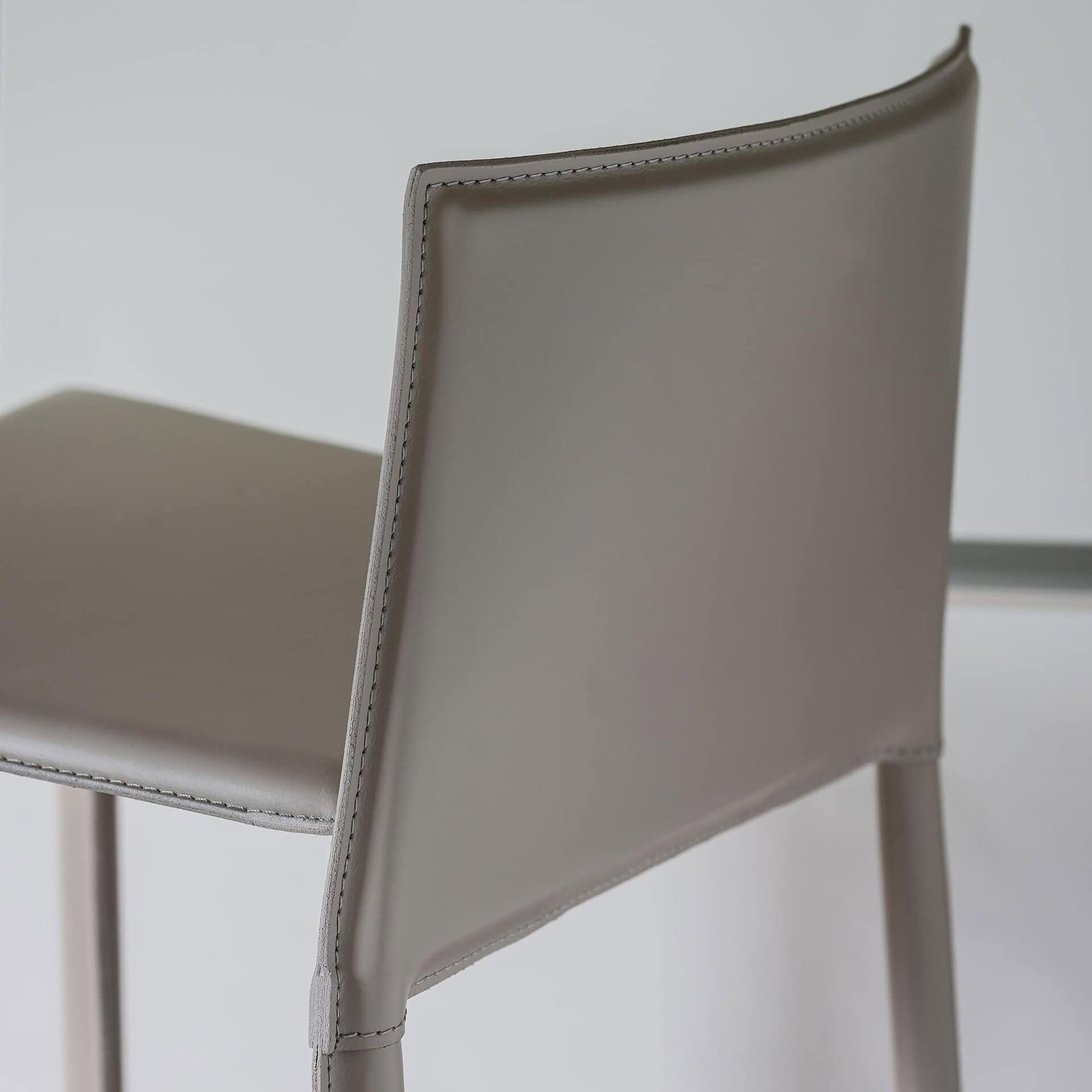 Side view of the Cliff Stool showcasing smooth leather upholstery and clean lines.