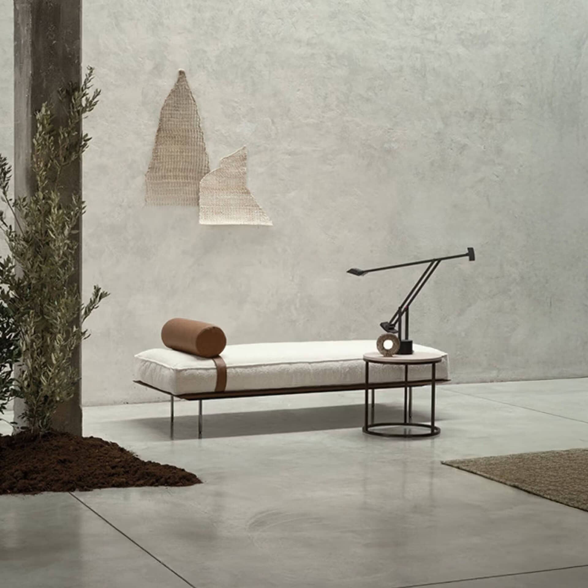 Modern minimalist bench with white cushion and black metal frame, stylish decor for contemporary spaces.