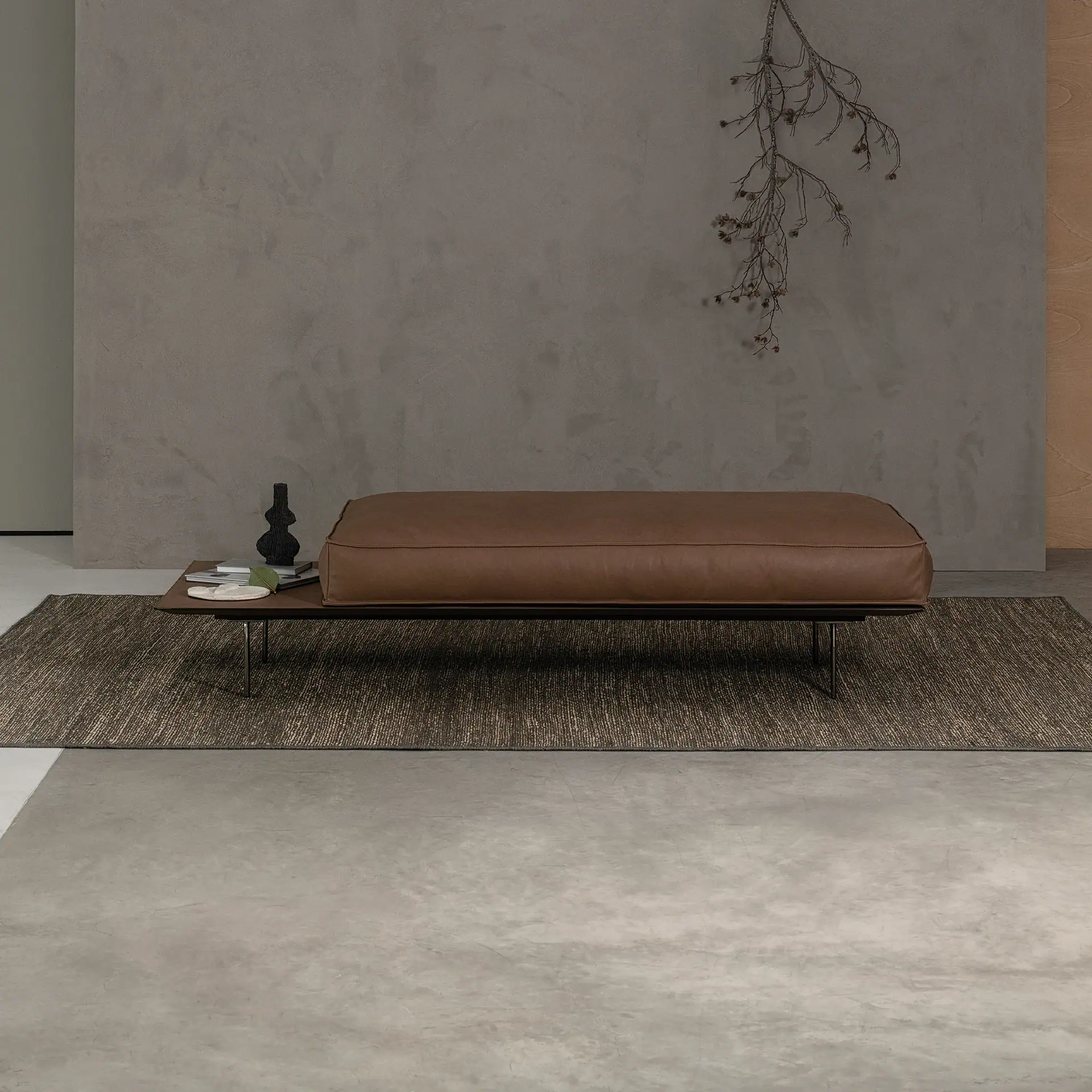 Stylish brown leather bench with side table in minimalist interior.