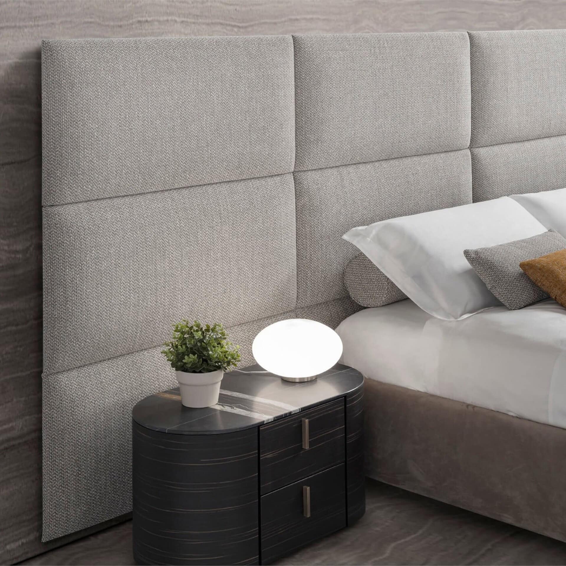 Close-up of Boiserie bed upholstered headboard panels with integrated nightstand for a sleek modern look.