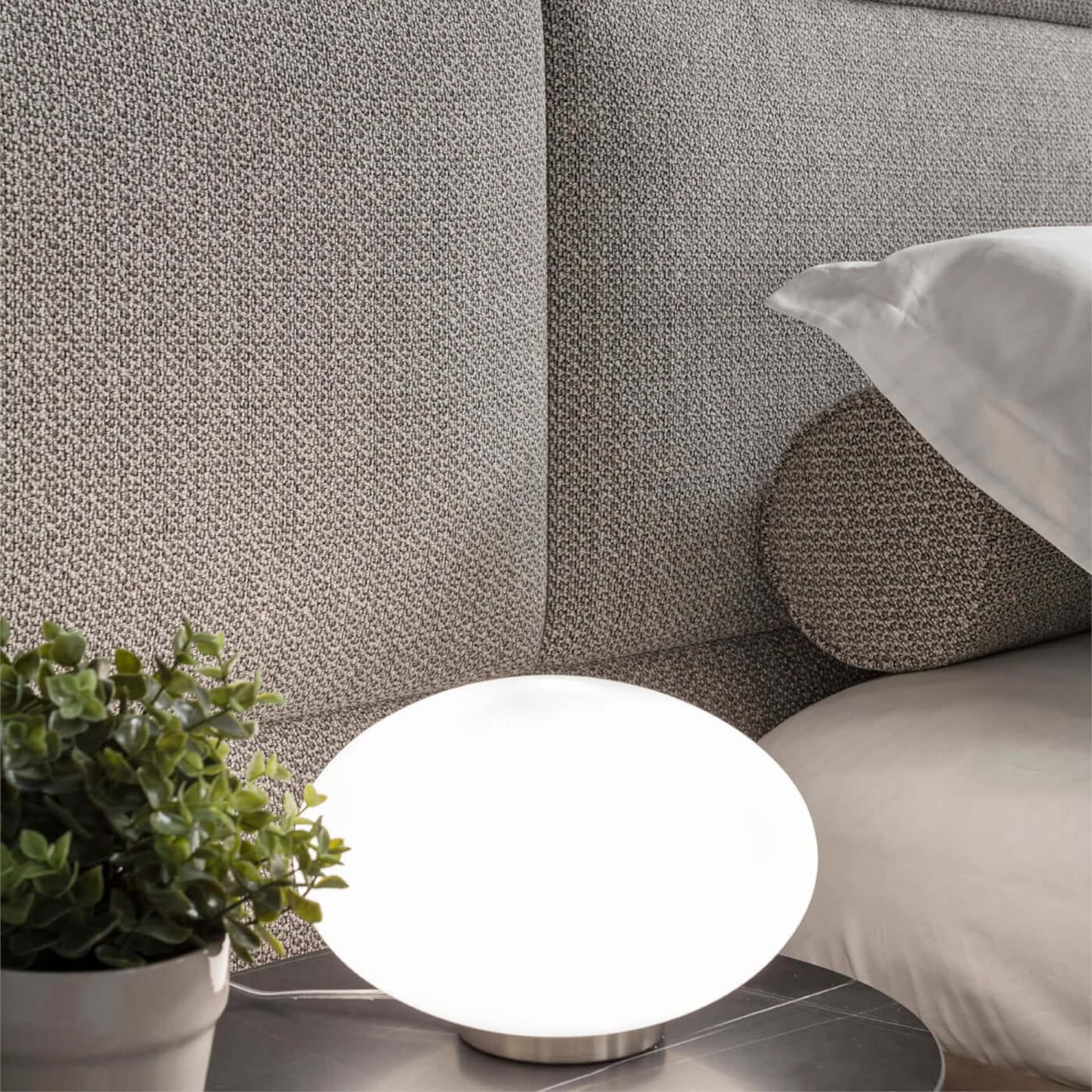 Detail of Boiserie bed headboard panel upholstery in cream fabric with contemporary styling.