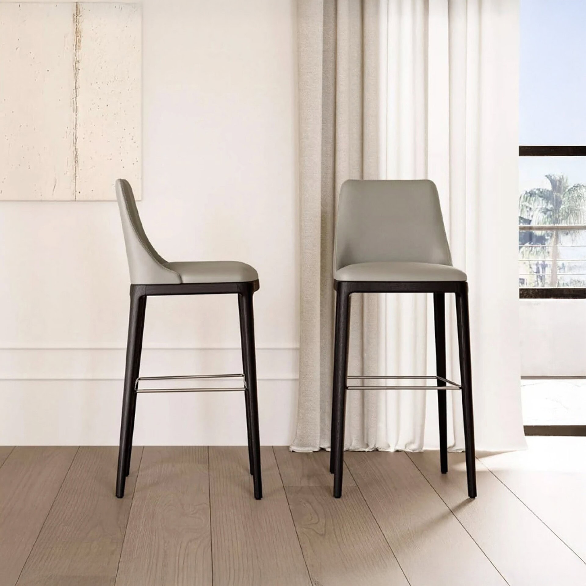 Max Stool Deluxe front view with upholstered seat and metal base.