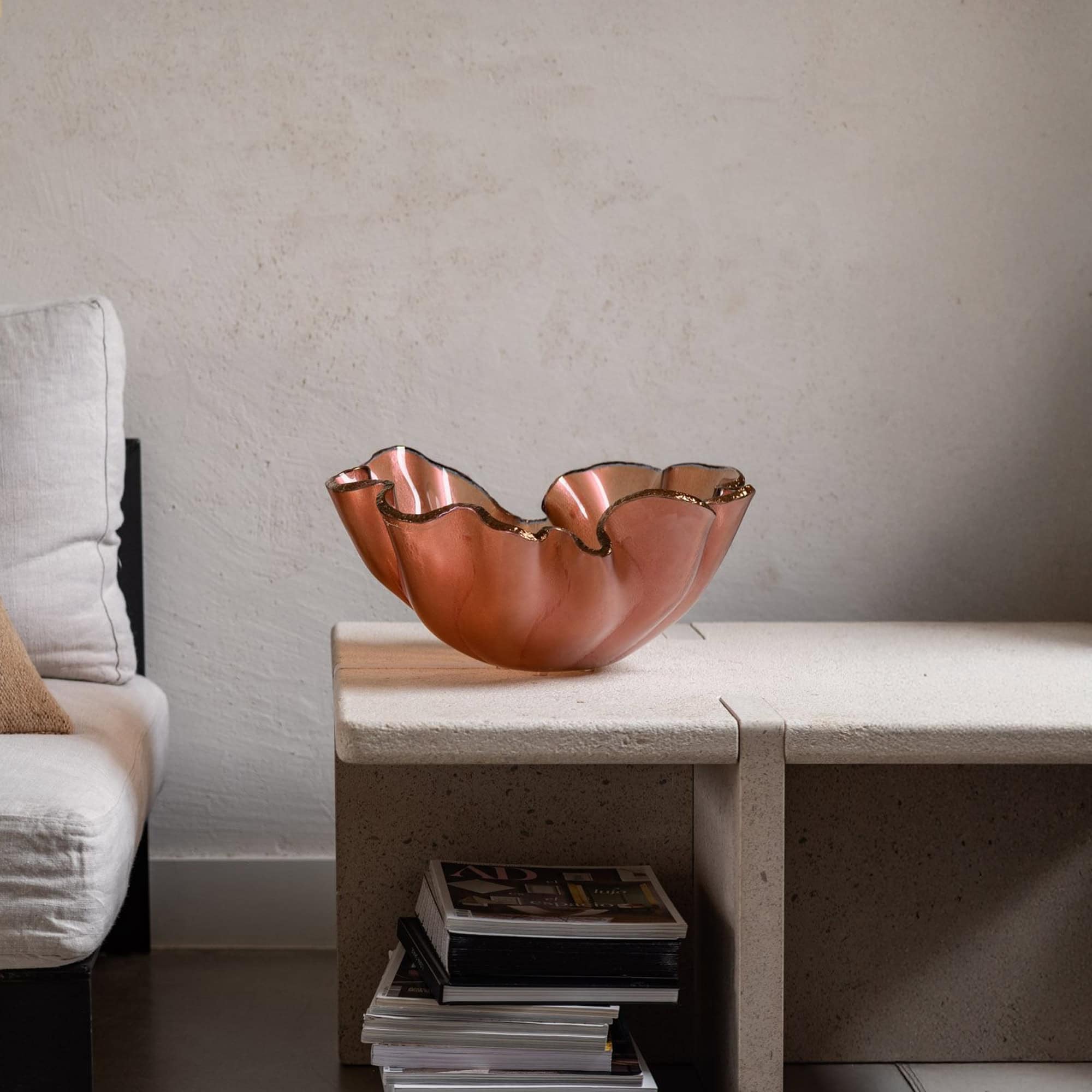 Bowl Lirio Glass Centerpiece in Rouge Topo Bronze finish styled on a modern side table.