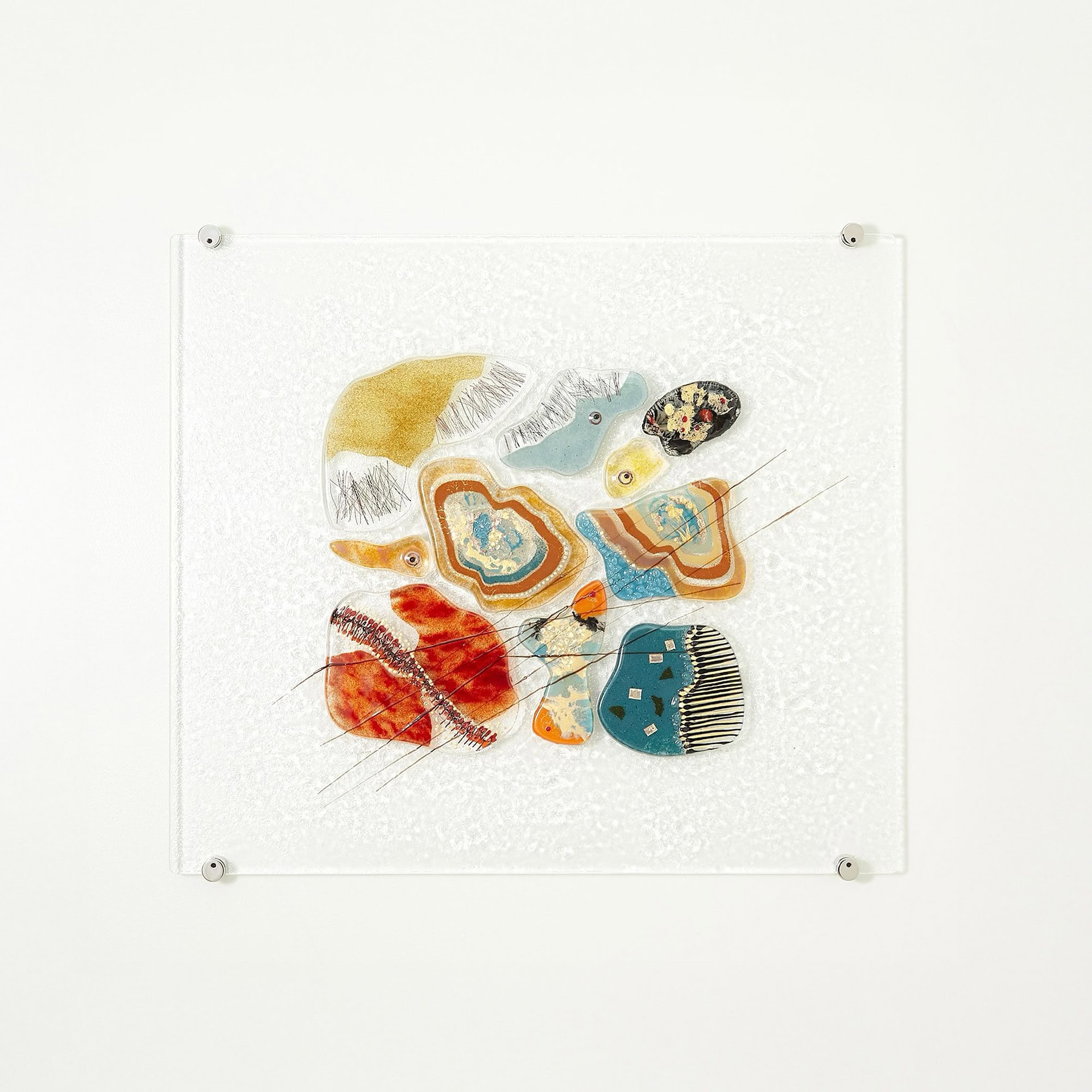 Fused Glass Wall Panel featuring warm-toned red and orange accents.