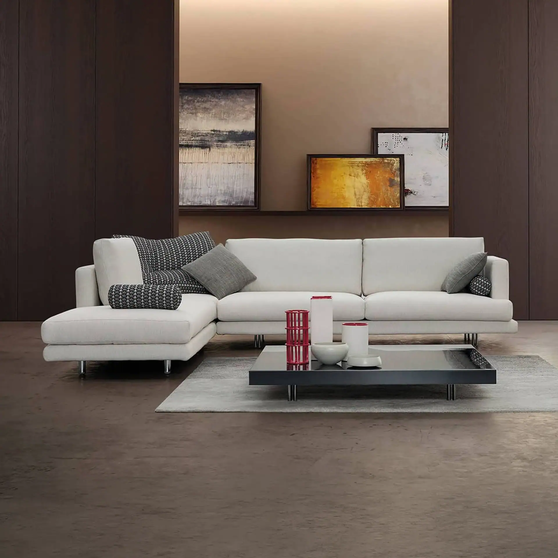 Luxury modern white sectional sofa with decorative cushions in contemporary living room.