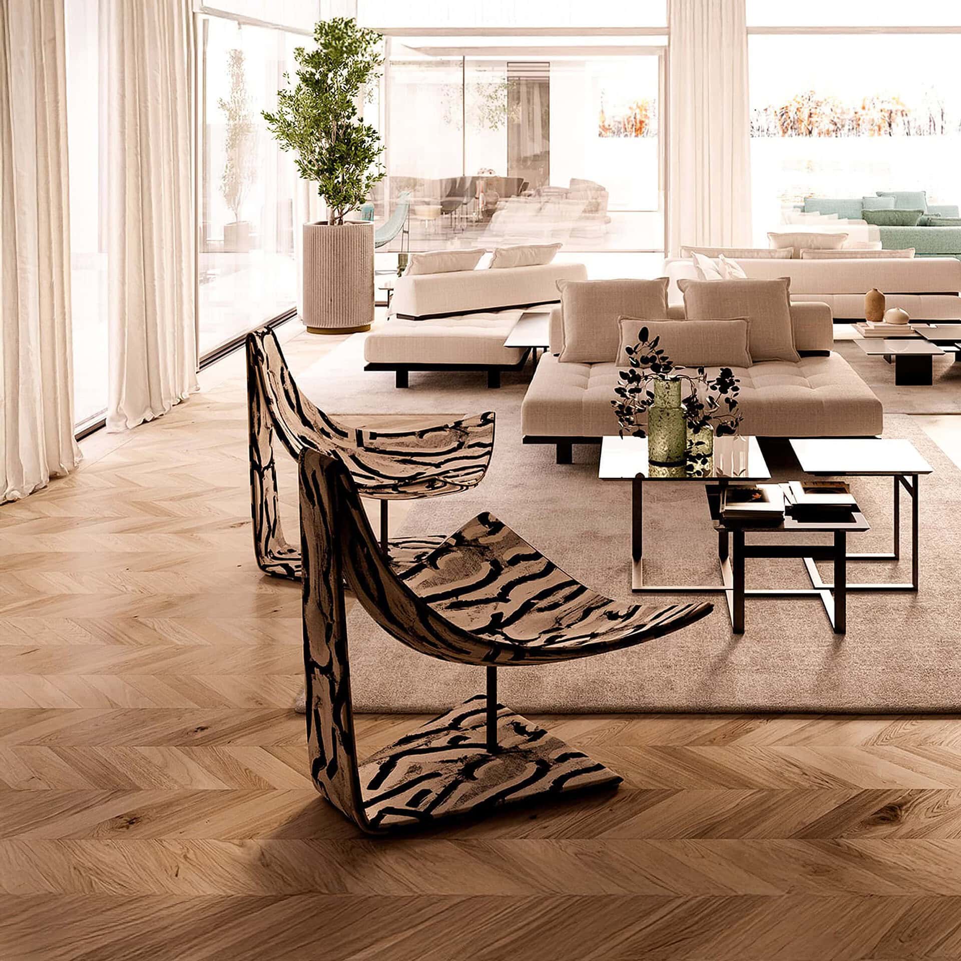 Giorgio Sculptural Armchair in black metal frame with leather seat shown in a contemporary living room.