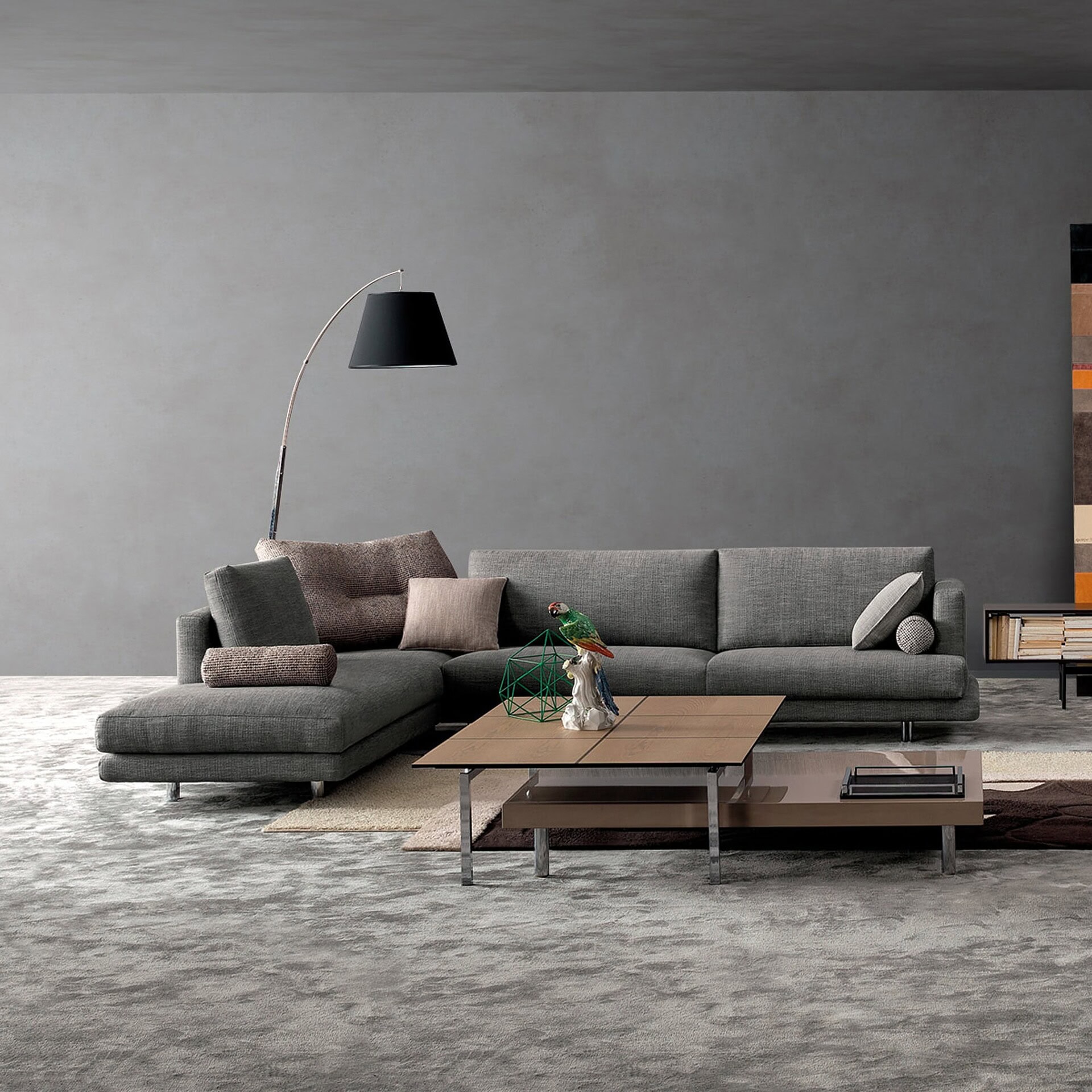 Contemporary gray sectional sofa with decorative cushions in a modern living room.