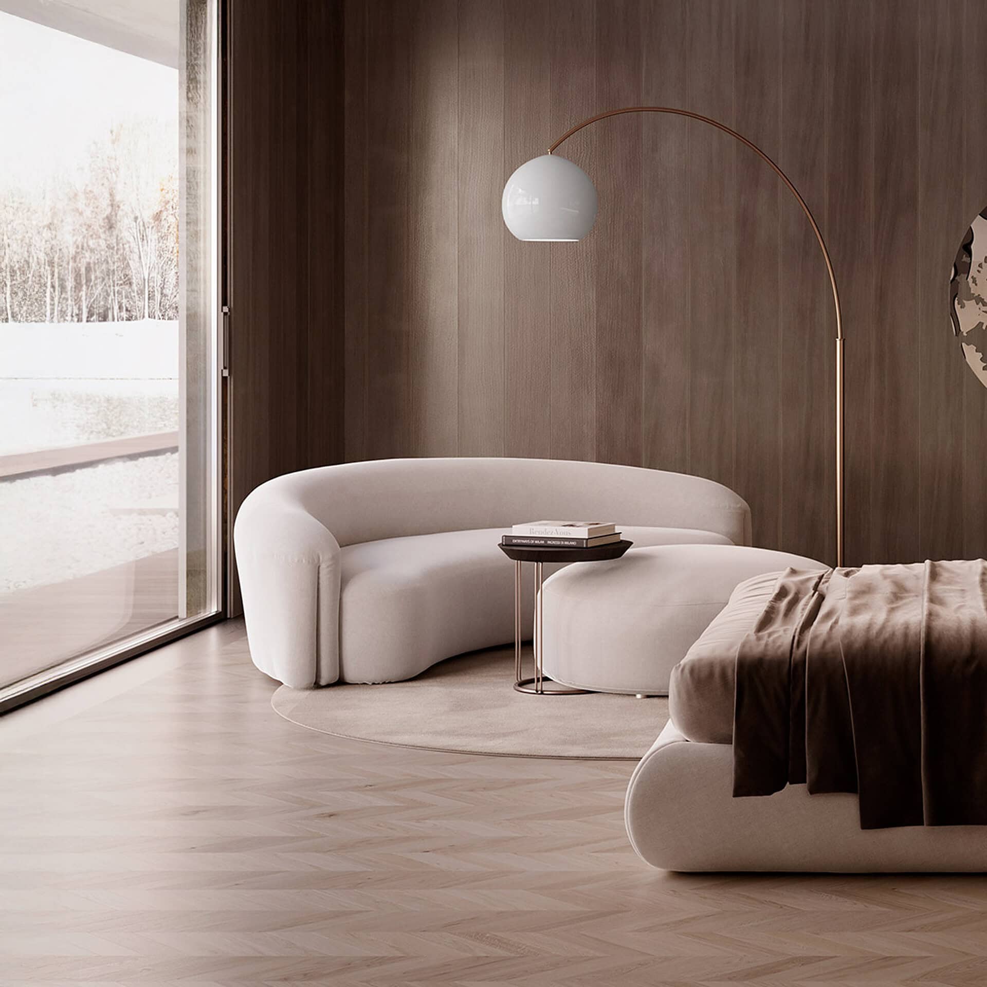 A modern living room featuring a curved off-white sofa, a dark wood paneled wall, a herringbone wood floor, and a large window overlooking a snowy landscape. A gold arc lamp and a dark velvet throw blanket add warmth.