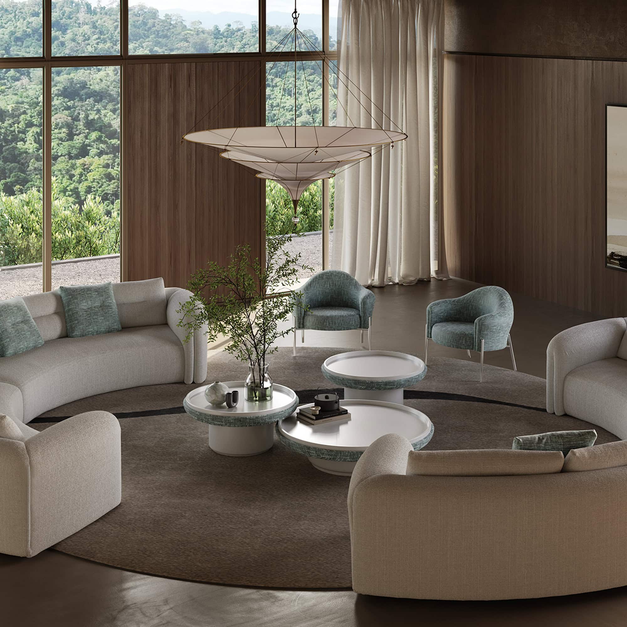 Modern living room with plush sectional and statement coffee tables surrounded by large windows.