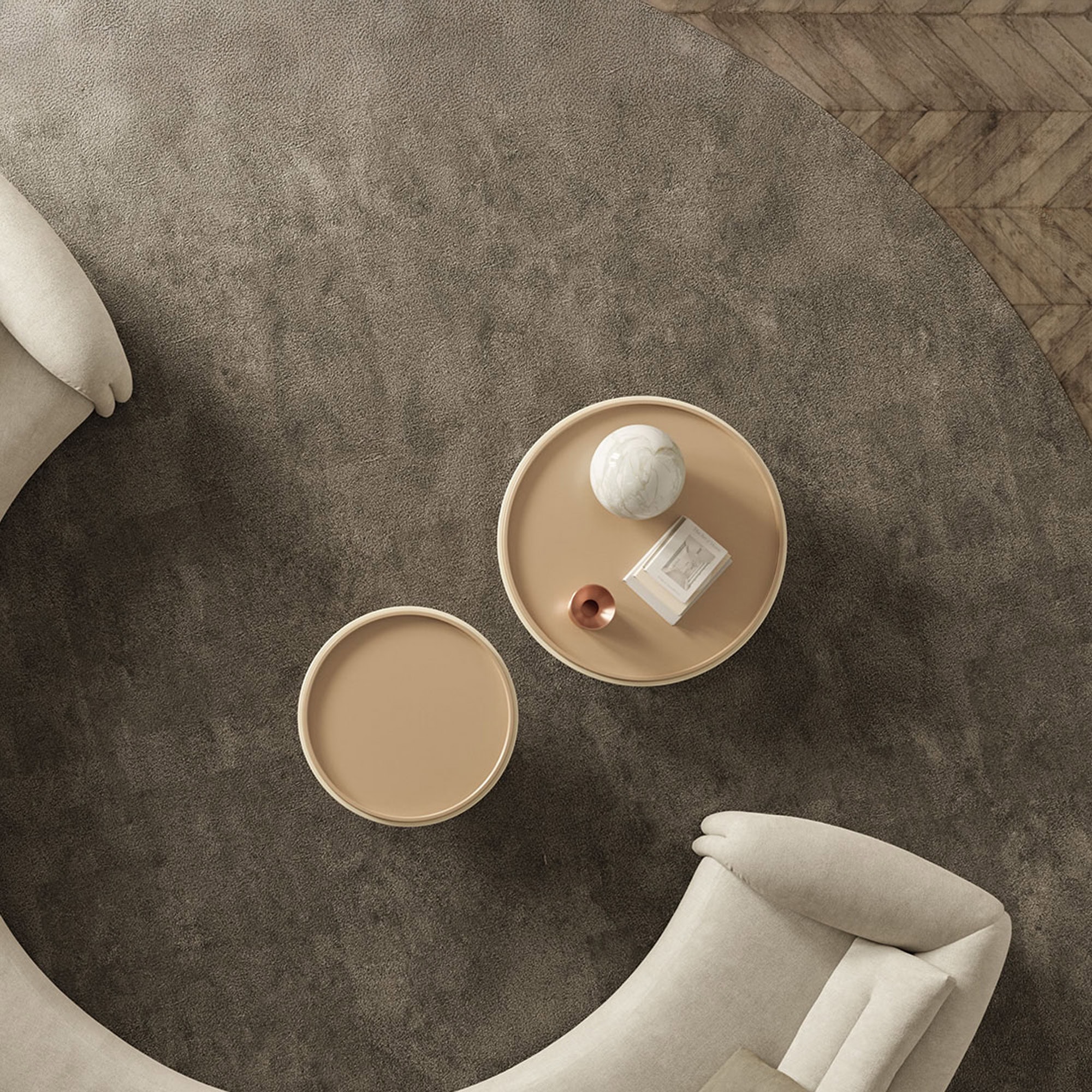 Elegant beige coffee tables with decorative items on a plush textured rug.
