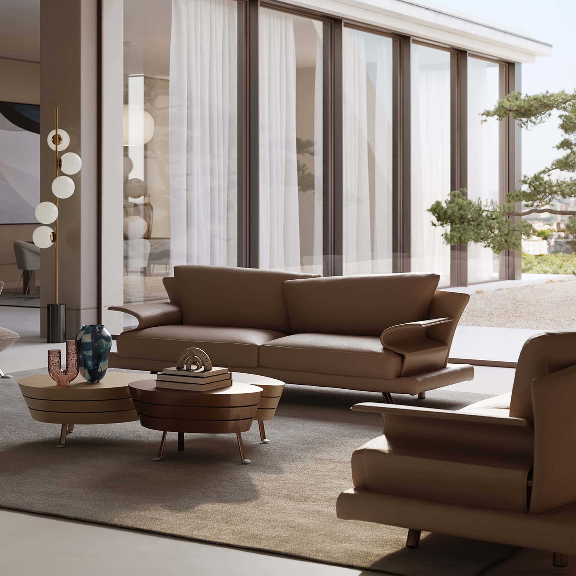 Elegant modern living room with neutral-toned sofa and stylish coffee tables, large windows, and contemporary decor.