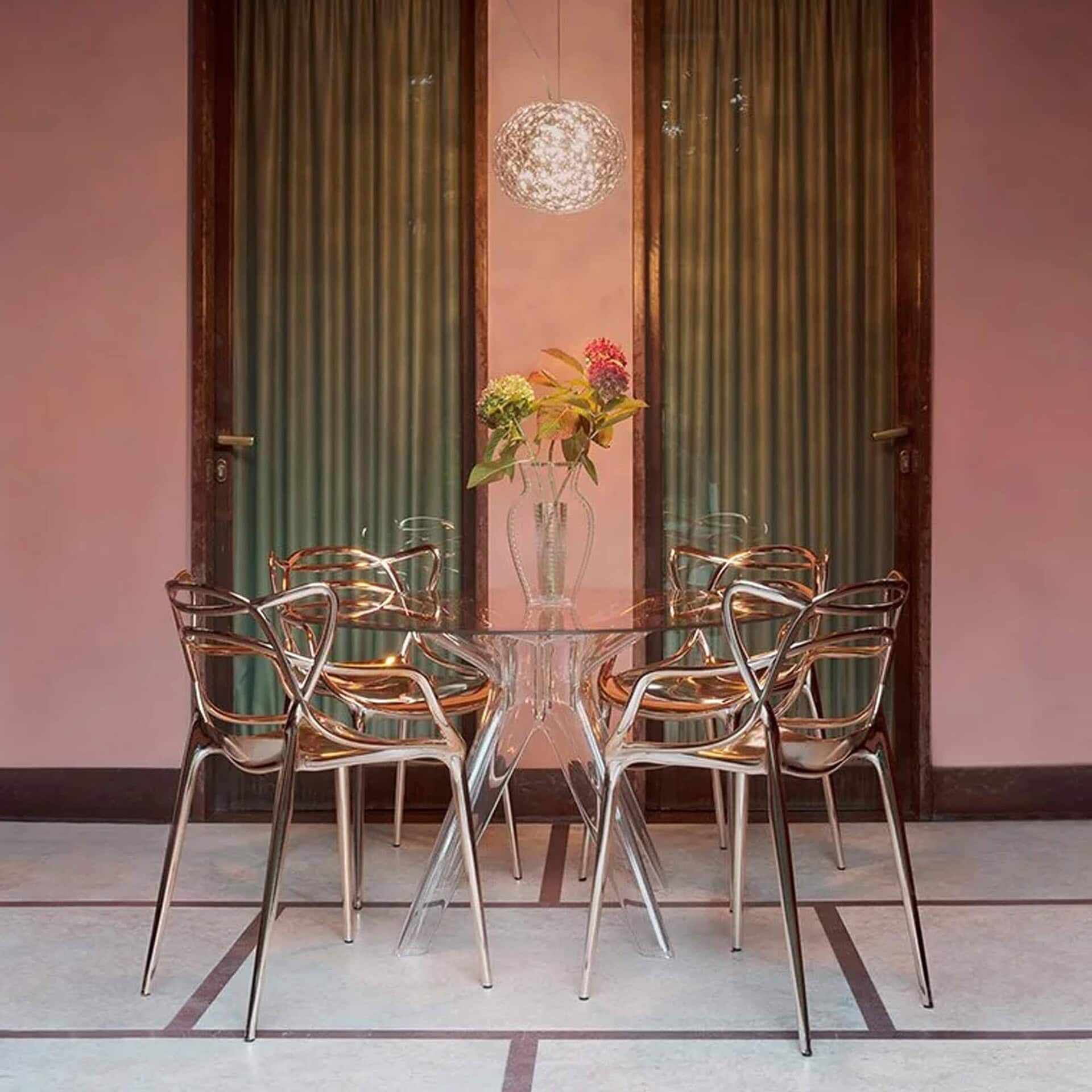 Pair of Masters Metal Dining Chairs in a chic contemporary room with tall curtains.