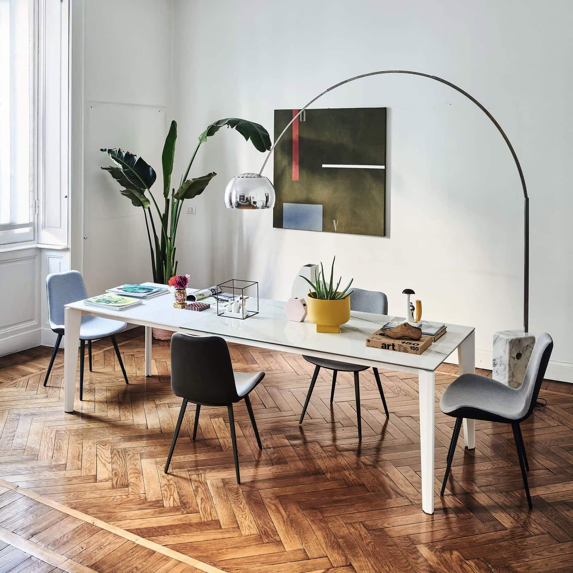 Diamond Extendable Dining Table styled in a modern dining room with wood flooring and contemporary chairs.