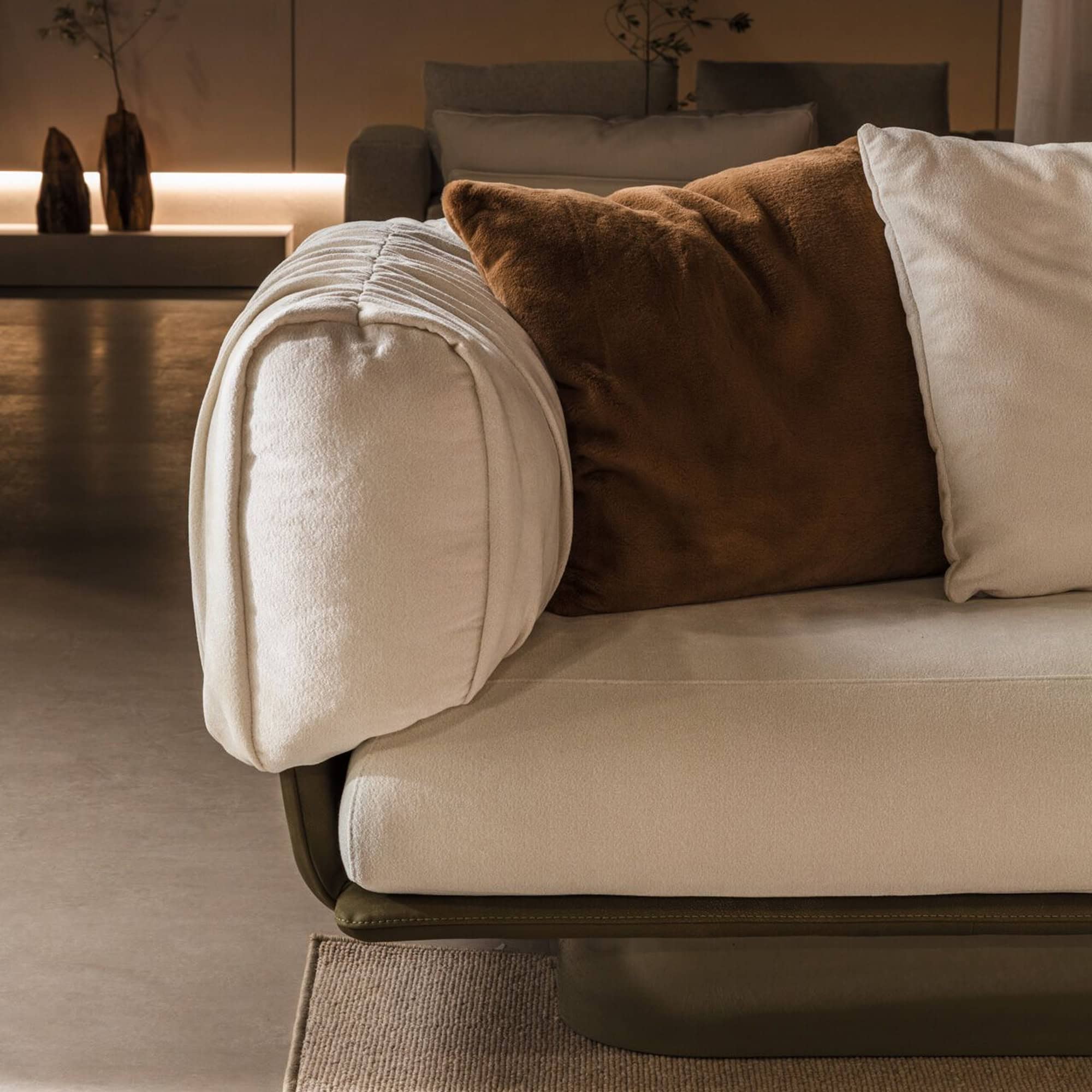 Armrest detail of the Break Sofa by Nicoline with contrasting cushion.