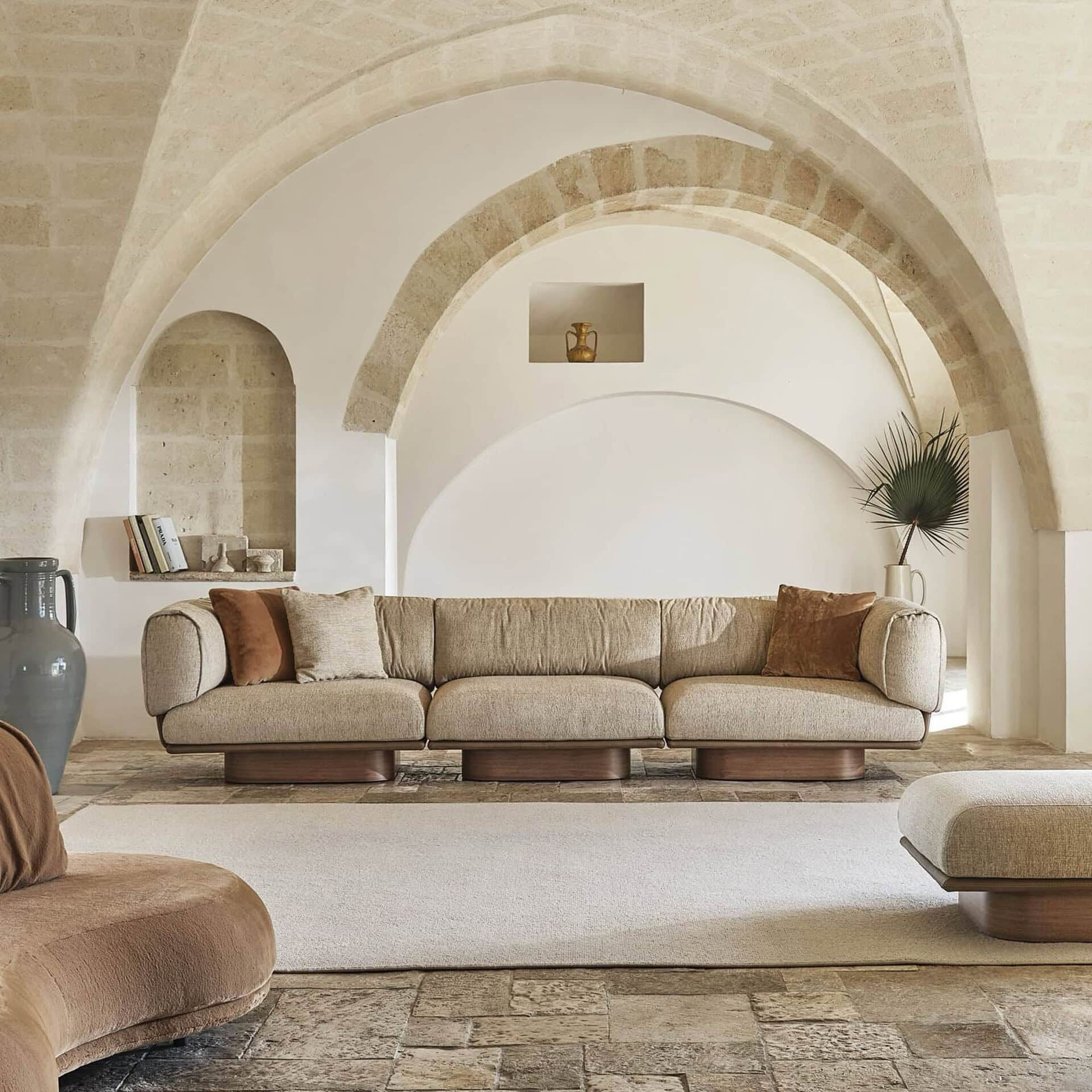 Luxurious beige sofa with rounded arms in elegant living room decor.