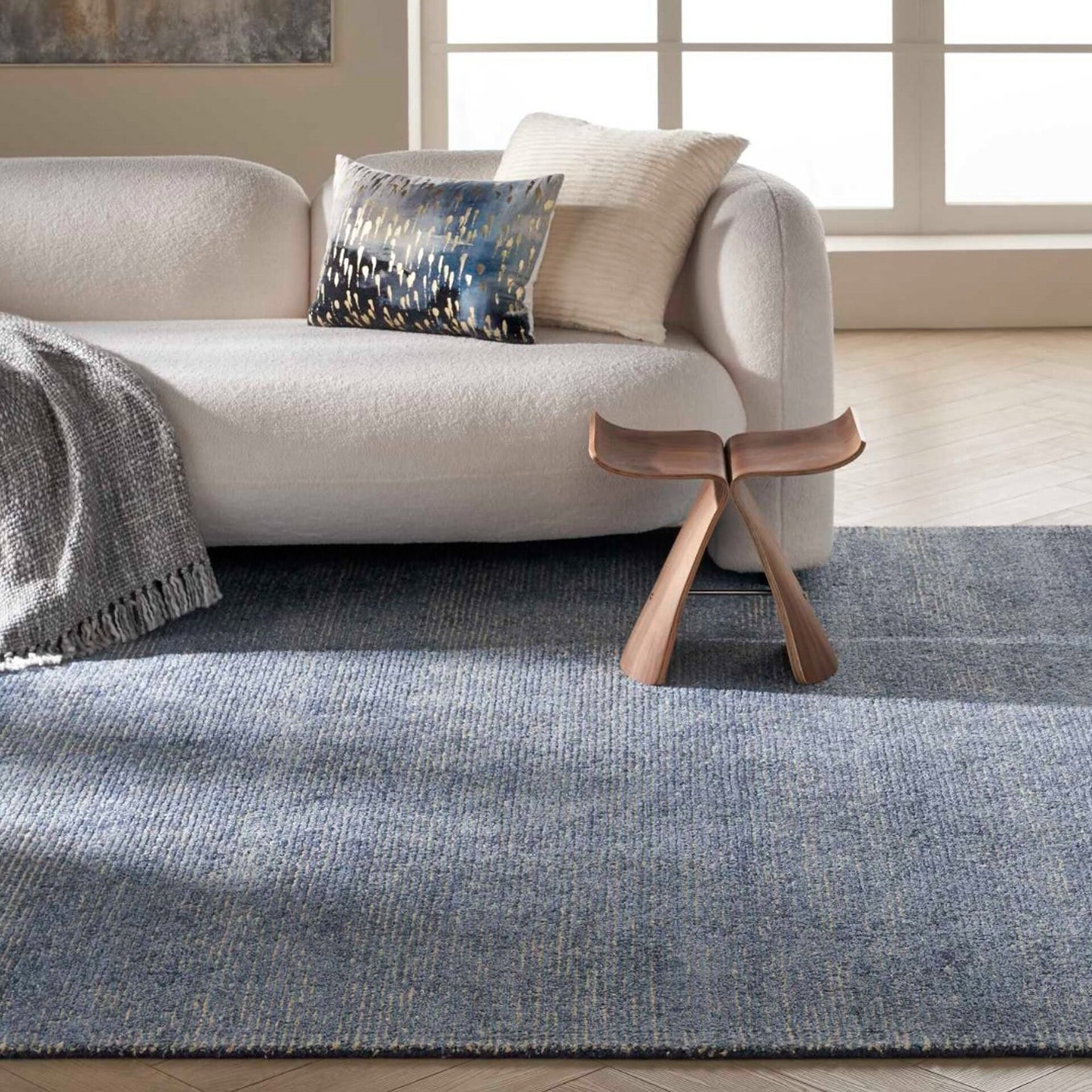 Weston WES01 Aegean Blue Rug styled under a sofa and side table in a modern living room.