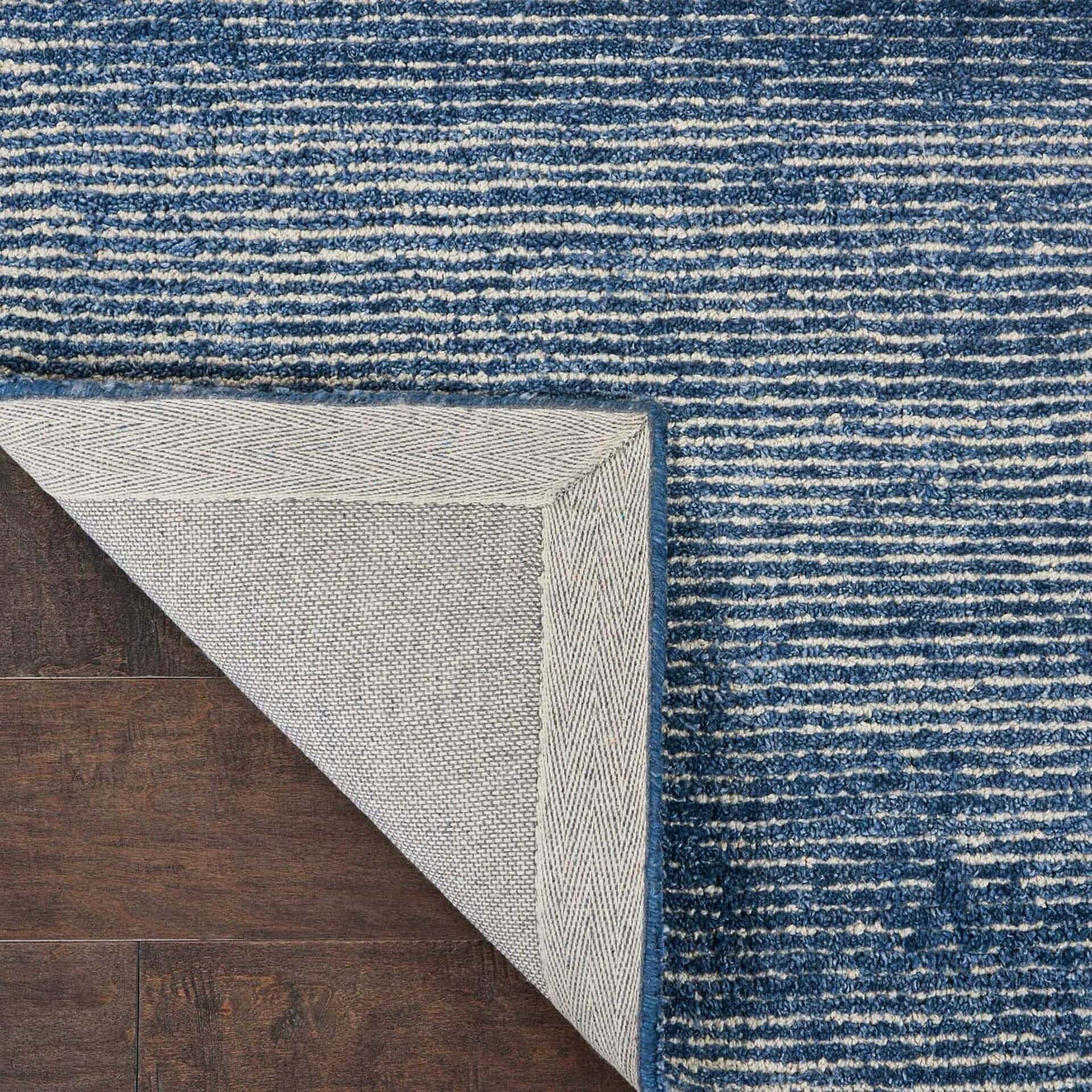 Backing detail of the Weston WES01 Aegean Blue Rug with corner folded to show underside.