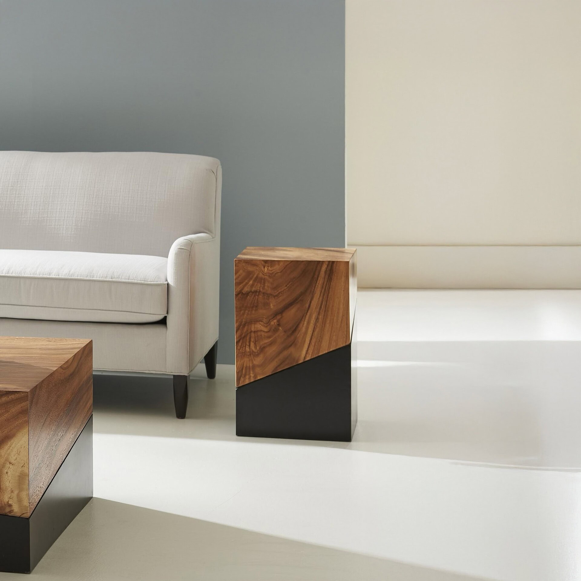 Geometry Side Table in natural finish placed next to a sofa in modern interior.