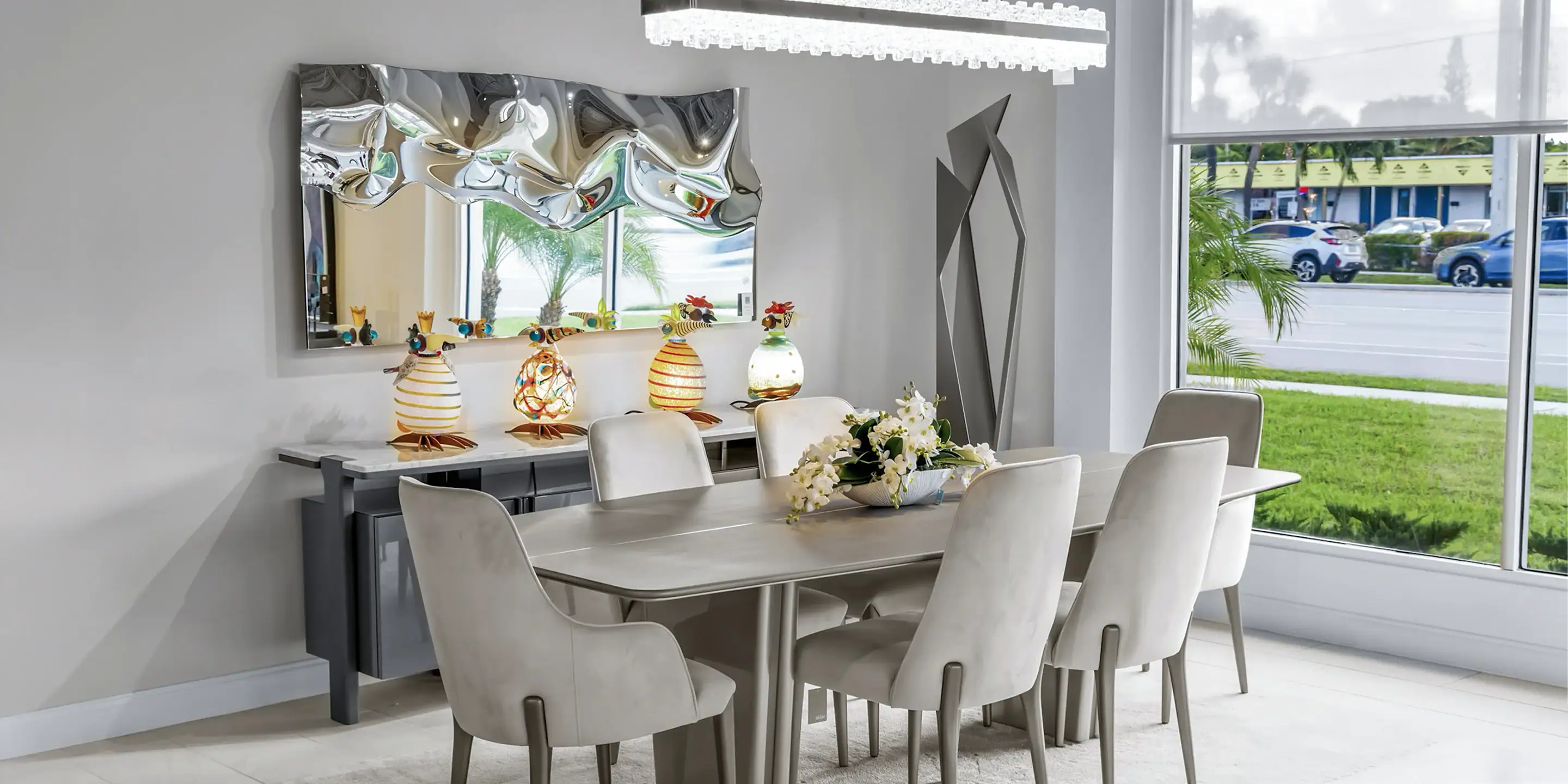 Contemporary dining room with sleek table and plush chairs, showcasing modern furniture design.