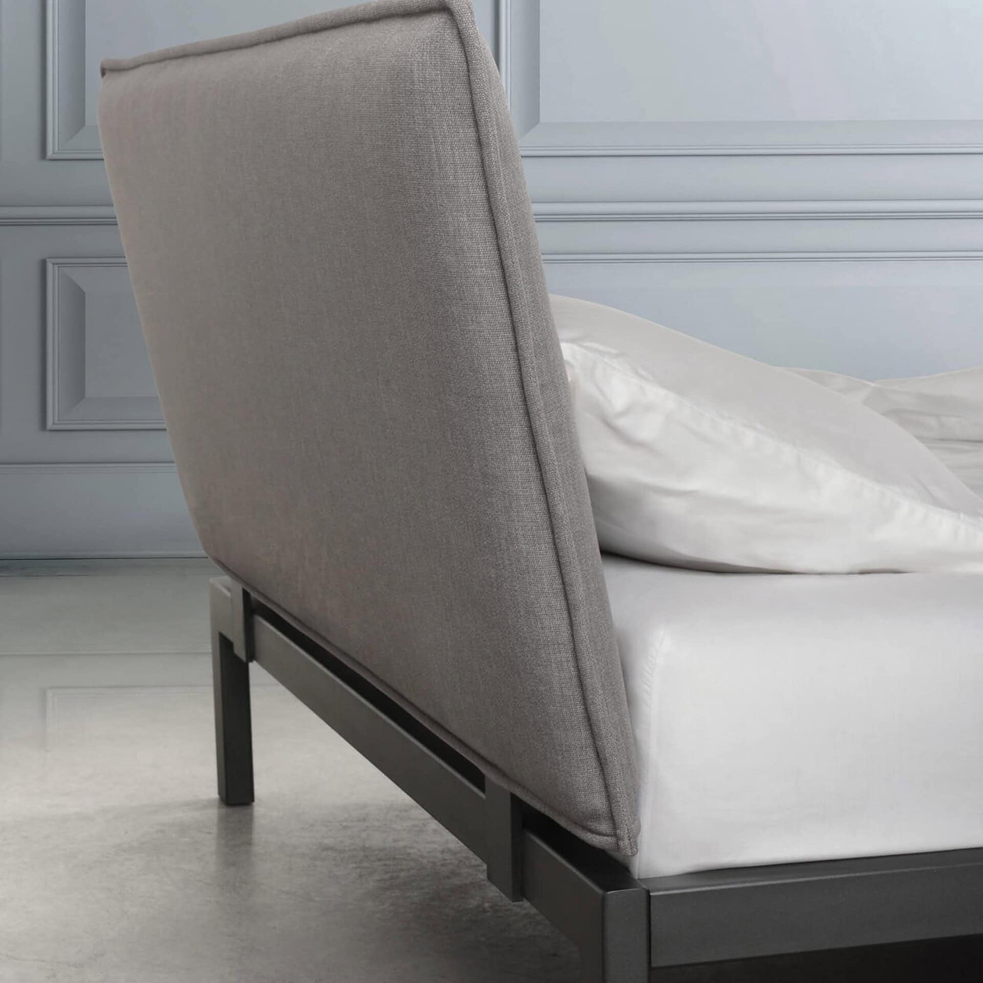 Side view of the Trica Dream Bed showcasing upholstered headboard and slim legs